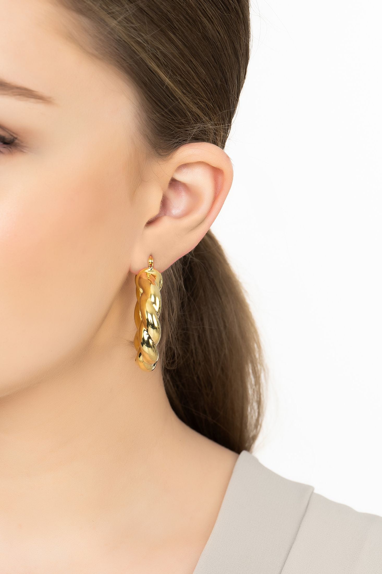 Angled view of Vintage Creole Hoop Earrings Gold, showing gold finish and the jewellery profile.