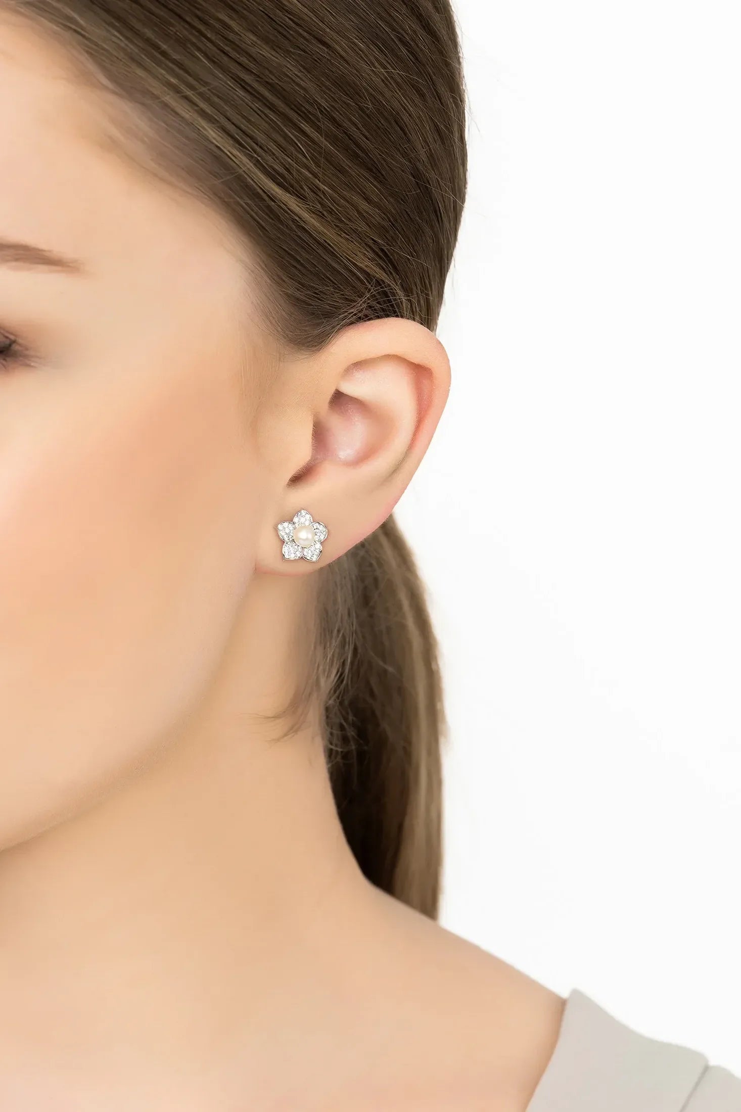 Angled view of Forget Me Not Pearl Stud Earrings Silver, showing pearl detailing, silver finish and the jewellery profile.