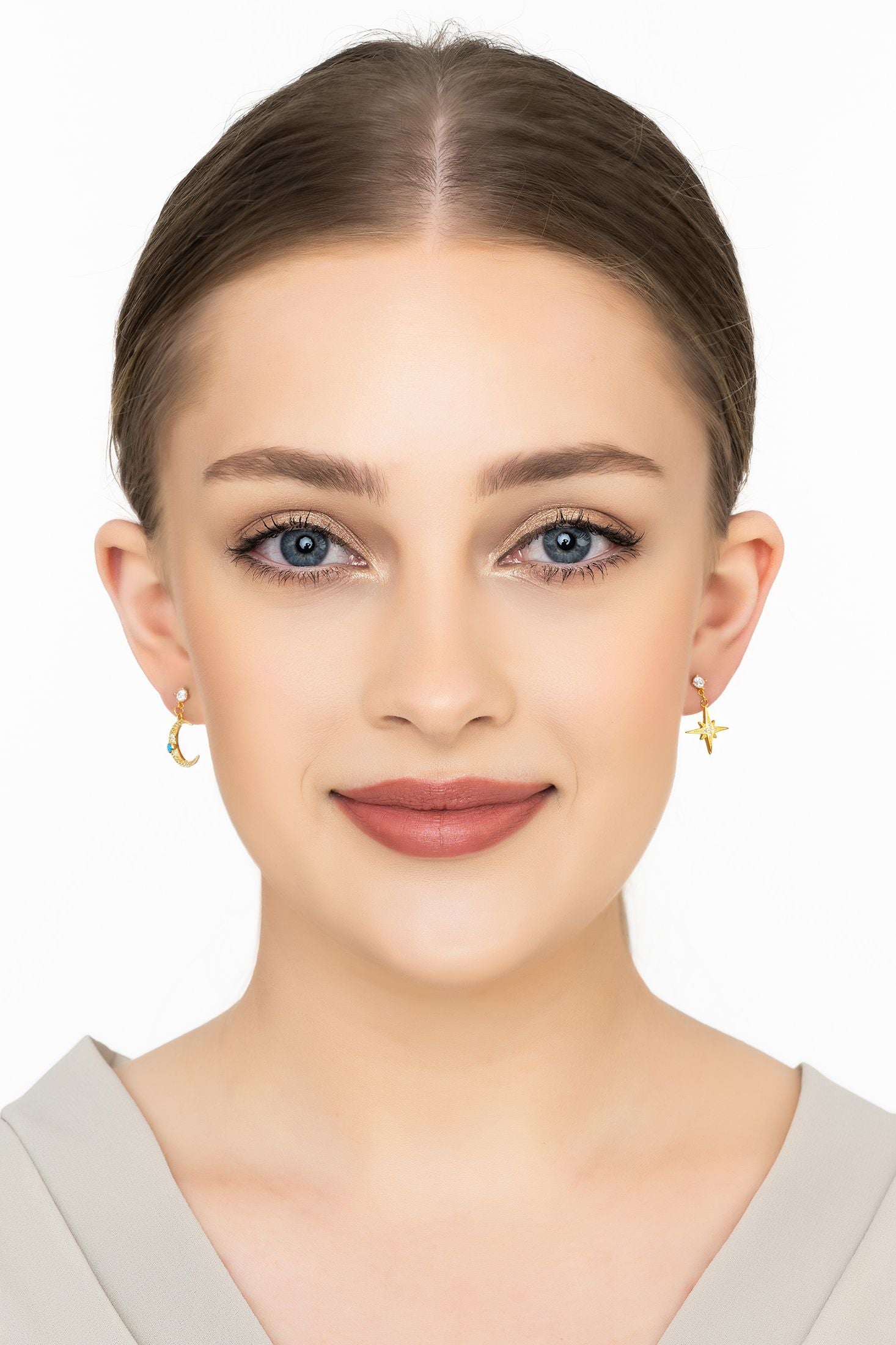 Angled view of Andromeda Star And Moon Earrings Gold, showing star design, gold finish and the jewellery profile.