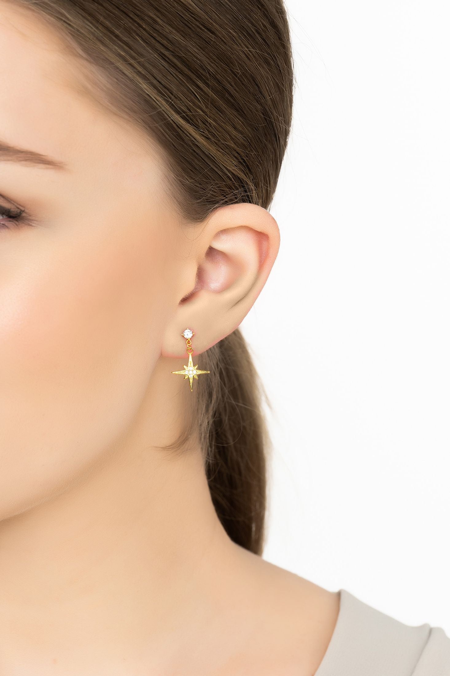 Angled view of Andromeda Star And Moon Earrings Gold, showing star design, gold finish and the jewellery profile.