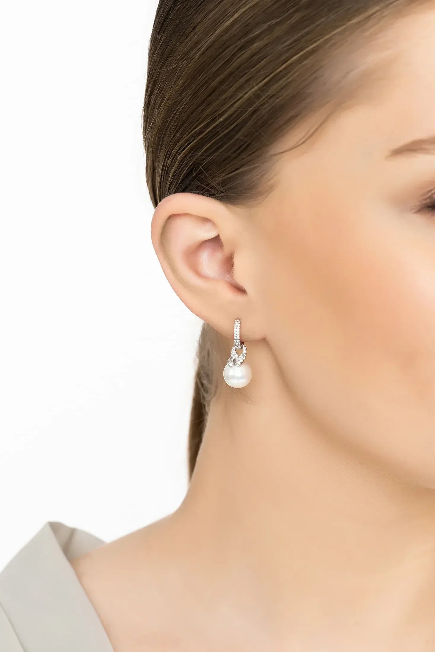 Angled view of Tie The Knot Drop Pearl Earrings Silver, showing pearl detailing, silver finish and the jewellery profile.