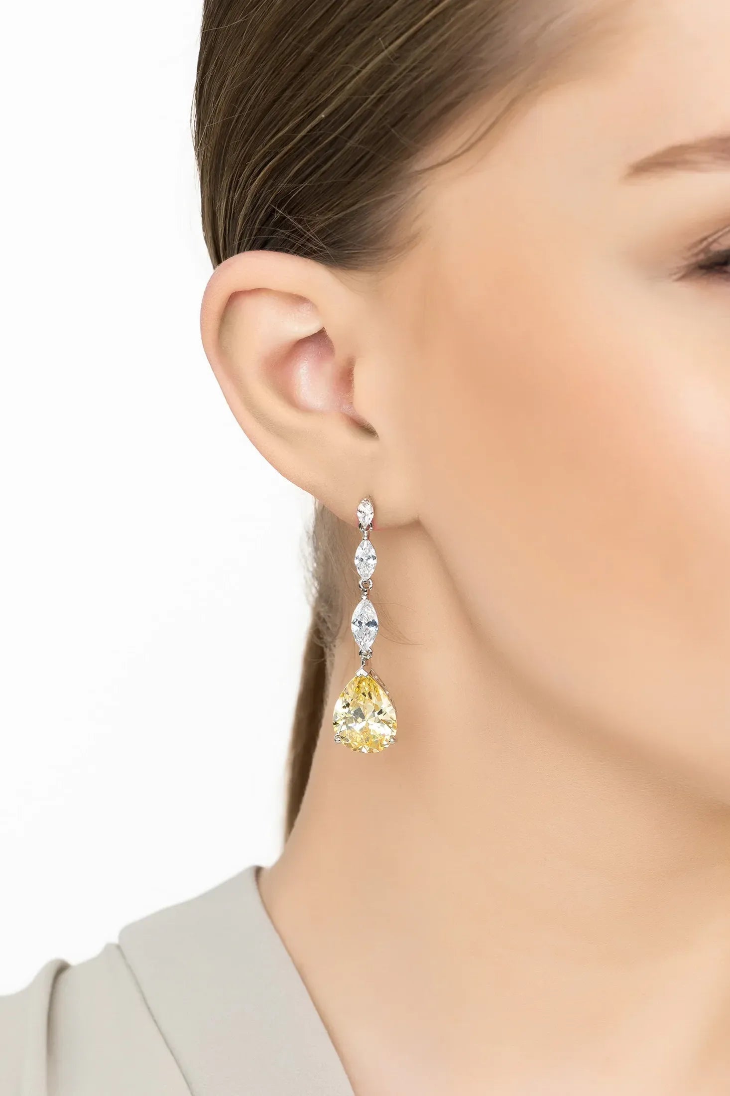 Angled view of Zara Teardrop Yellow Topaz Gemstone Earrings Silver, showing silver finish and the jewellery profile.