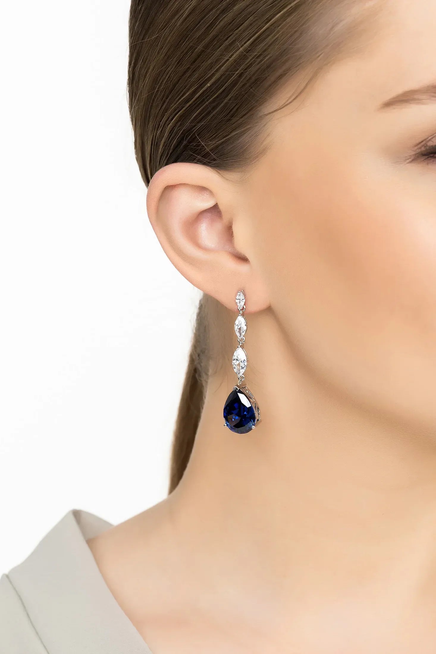 Angled view of Zara Teardrop Tanzanite Gemstone Earrings Silver, showing tanzanite detailing, silver finish and the jewellery profile.