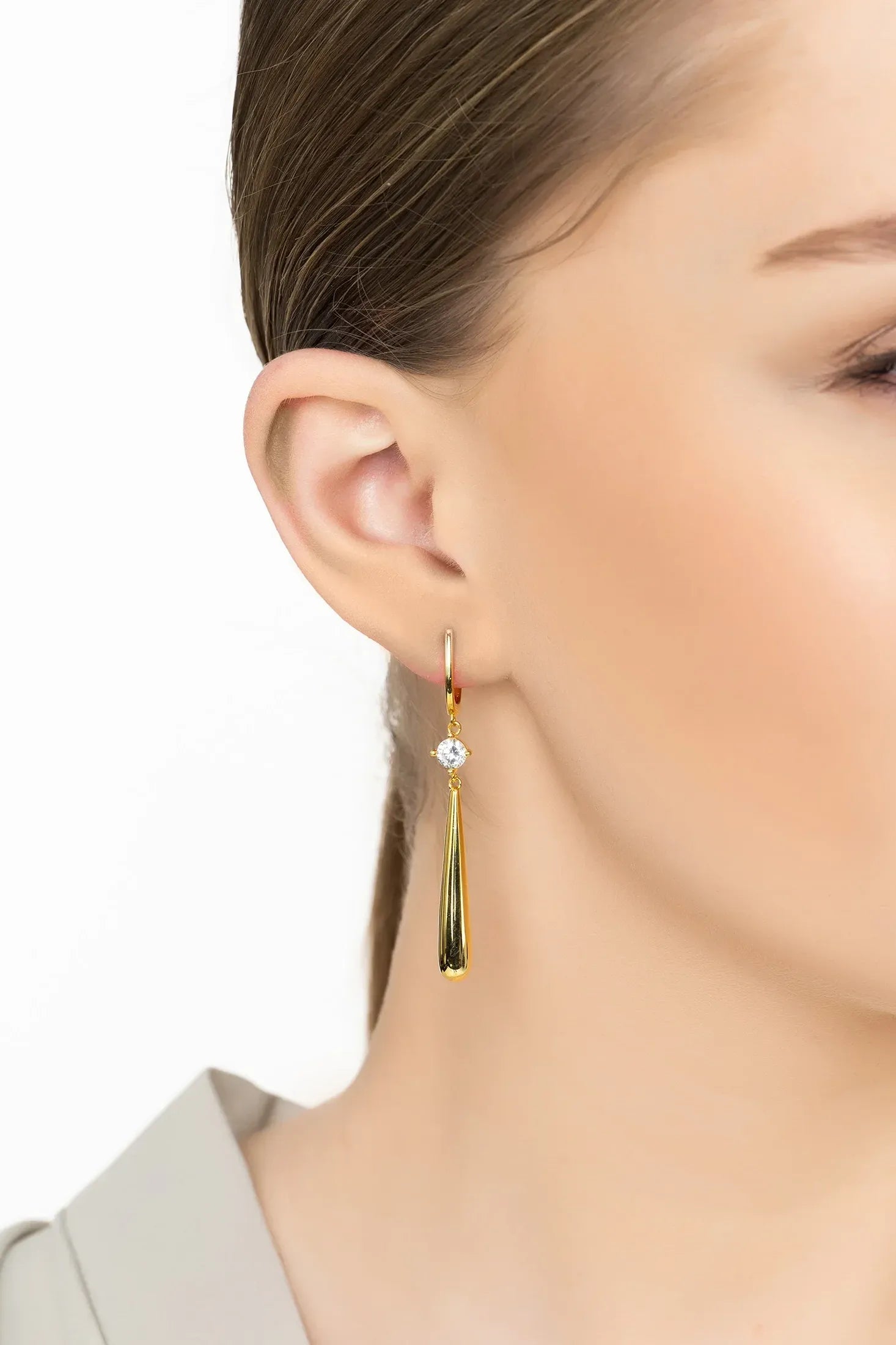 Angled view of Zen Droplet Earrings Gold, showing gold finish and the jewellery profile.
