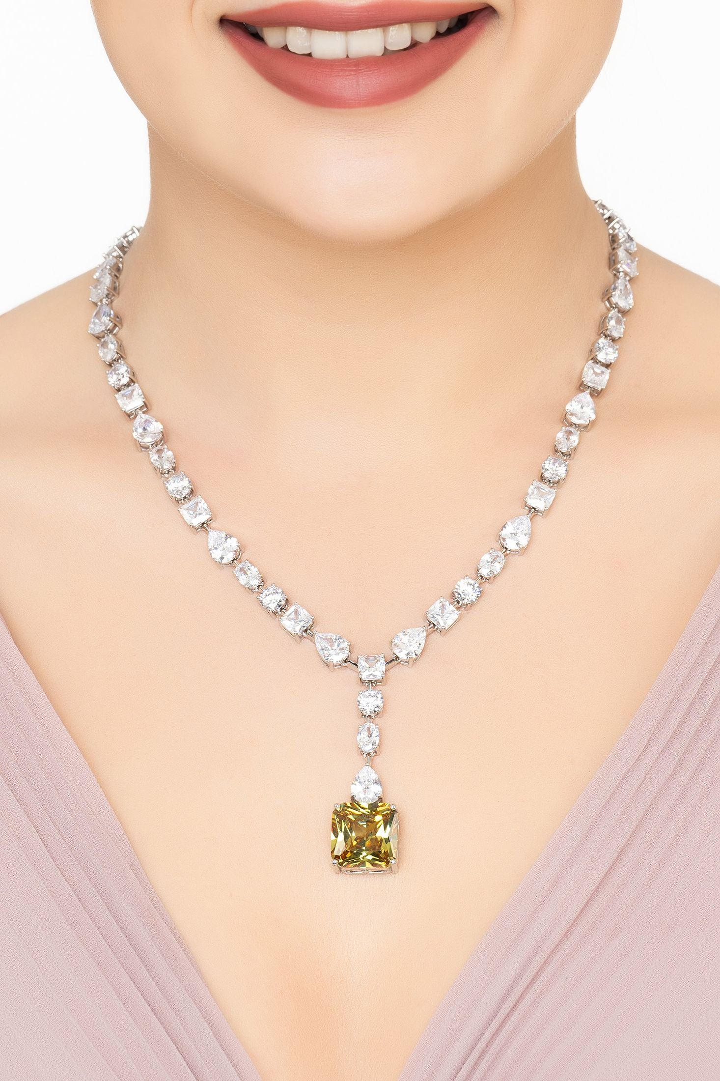 Angled view of Penelope Peridot Statement Necklace Silver, showing peridot detailing, silver finish and the jewellery profile.