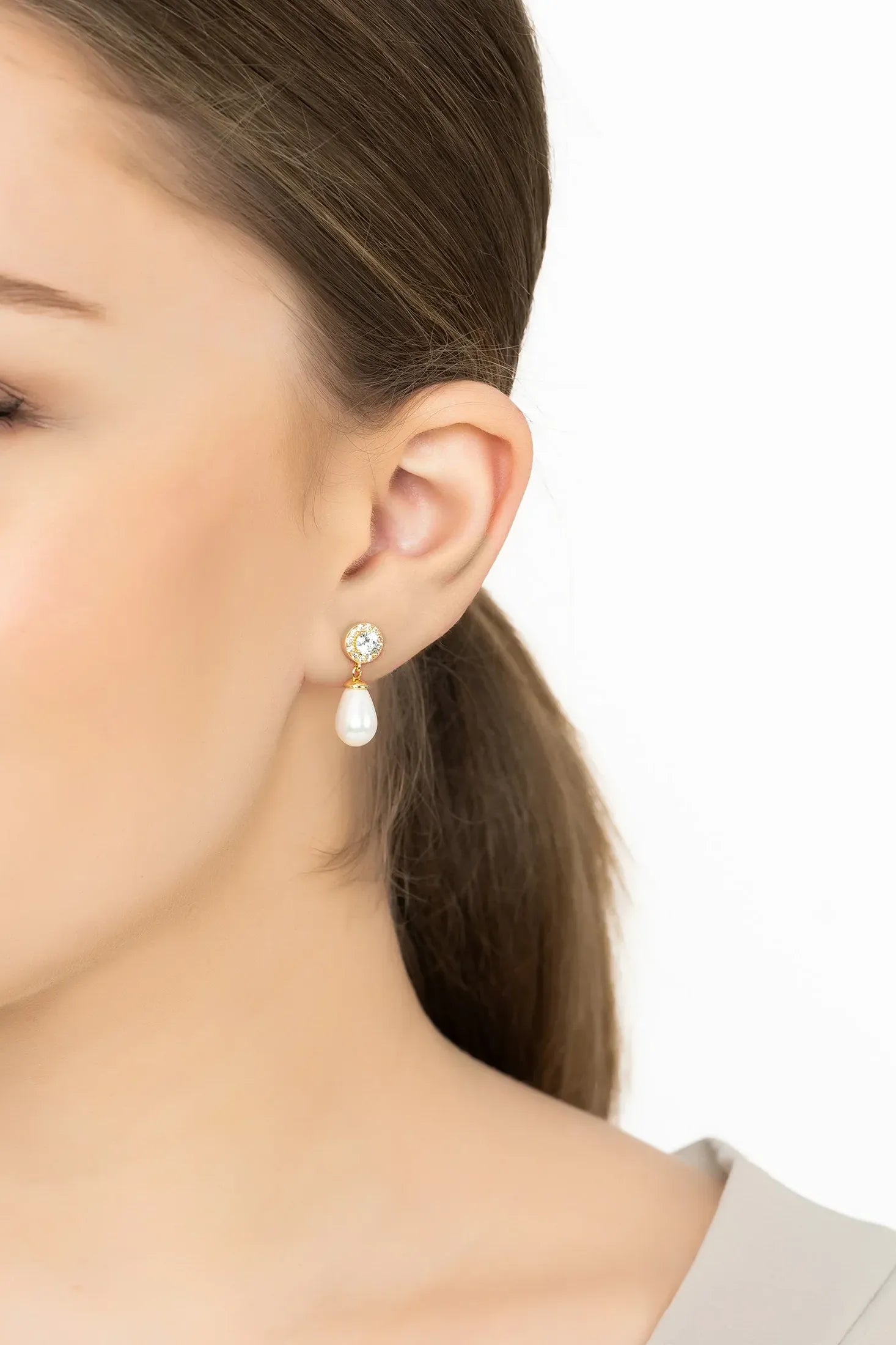 Angled view of Timeless Pearl Teardrop Earrings Gold, showing pearl detailing, gold finish and the jewellery profile.