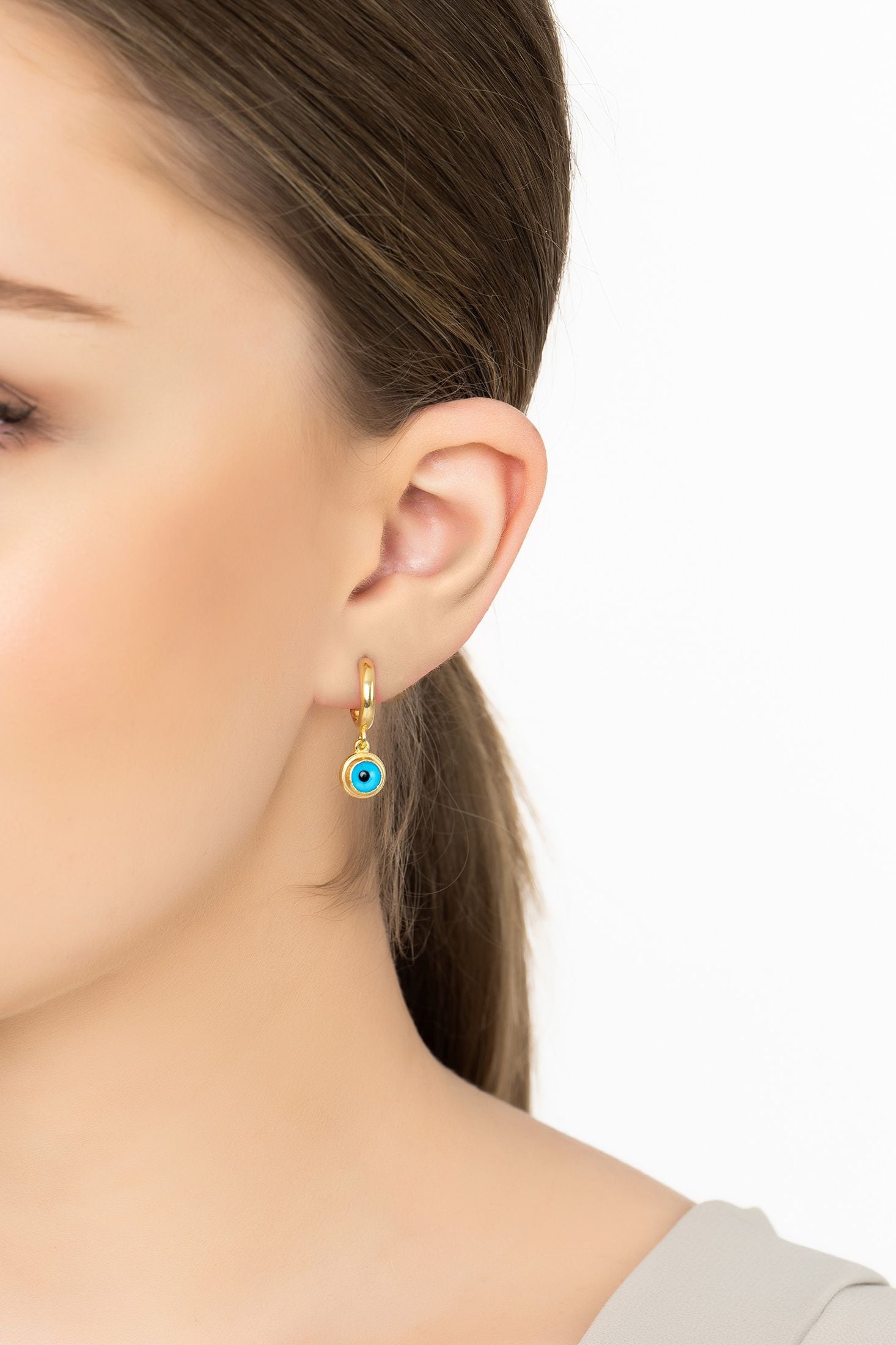 Angled view of Evil Eye Drop Earrings Gold, showing evil eye design, gold finish and the jewellery profile.