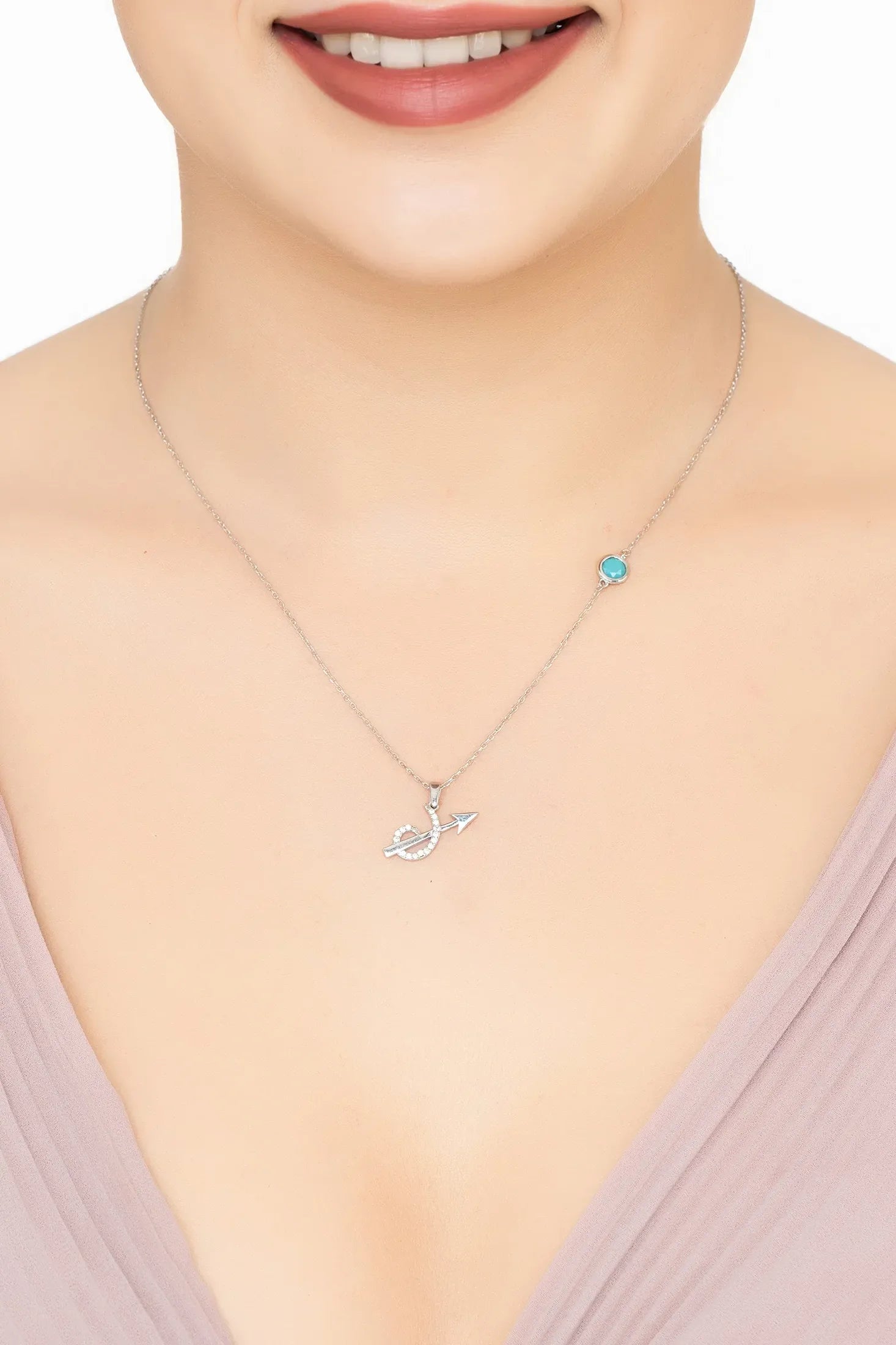 Angled view of Zodiac Birthstone Sagittarius Necklace Turquoise Silver, showing zodiac design, turquoise detailing, silver finish and the jewellery profile.