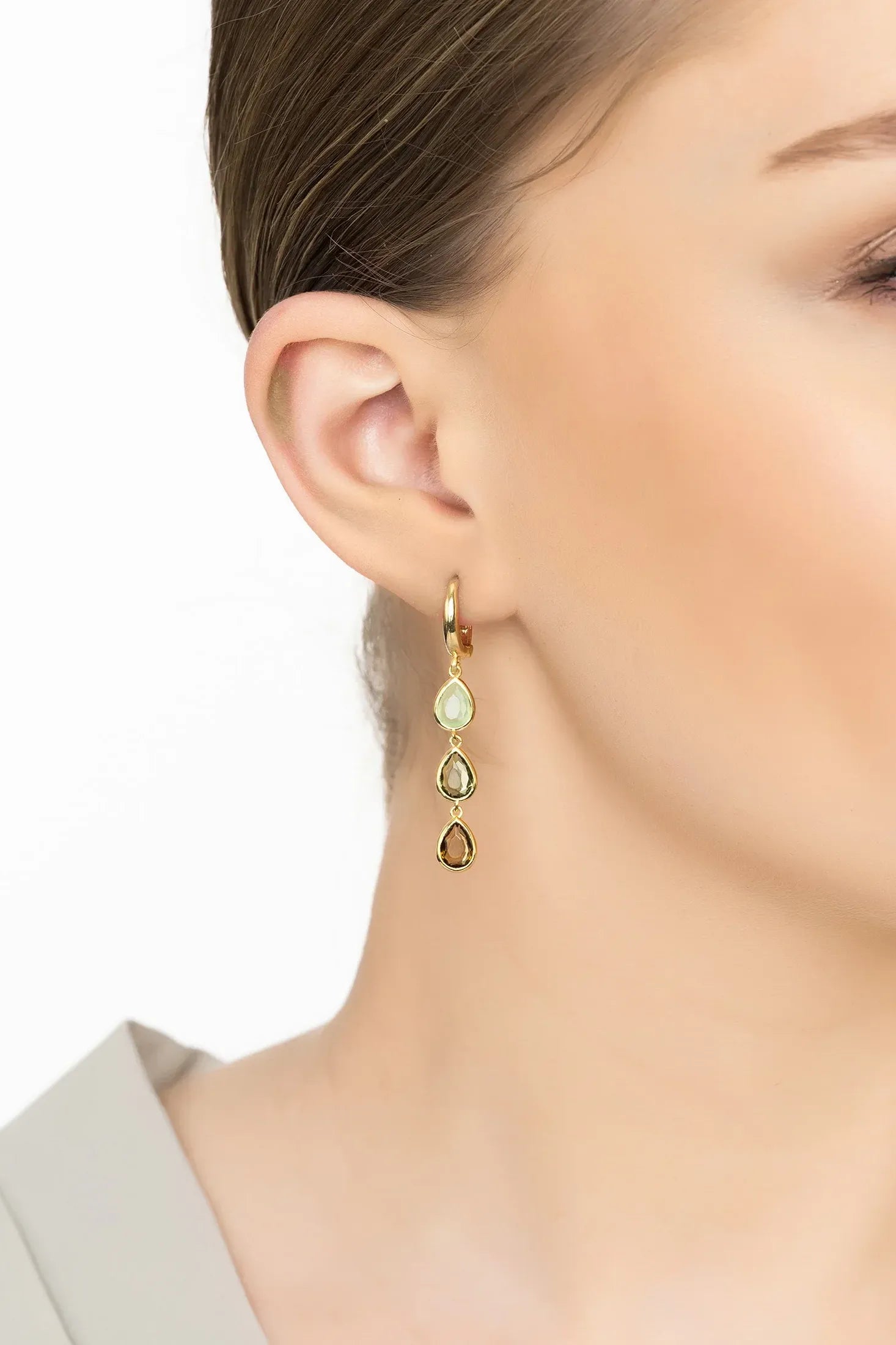 Angled view of Sardinia Triple Teardrop Earrings Gold The Greens, showing gold finish and the jewellery profile.