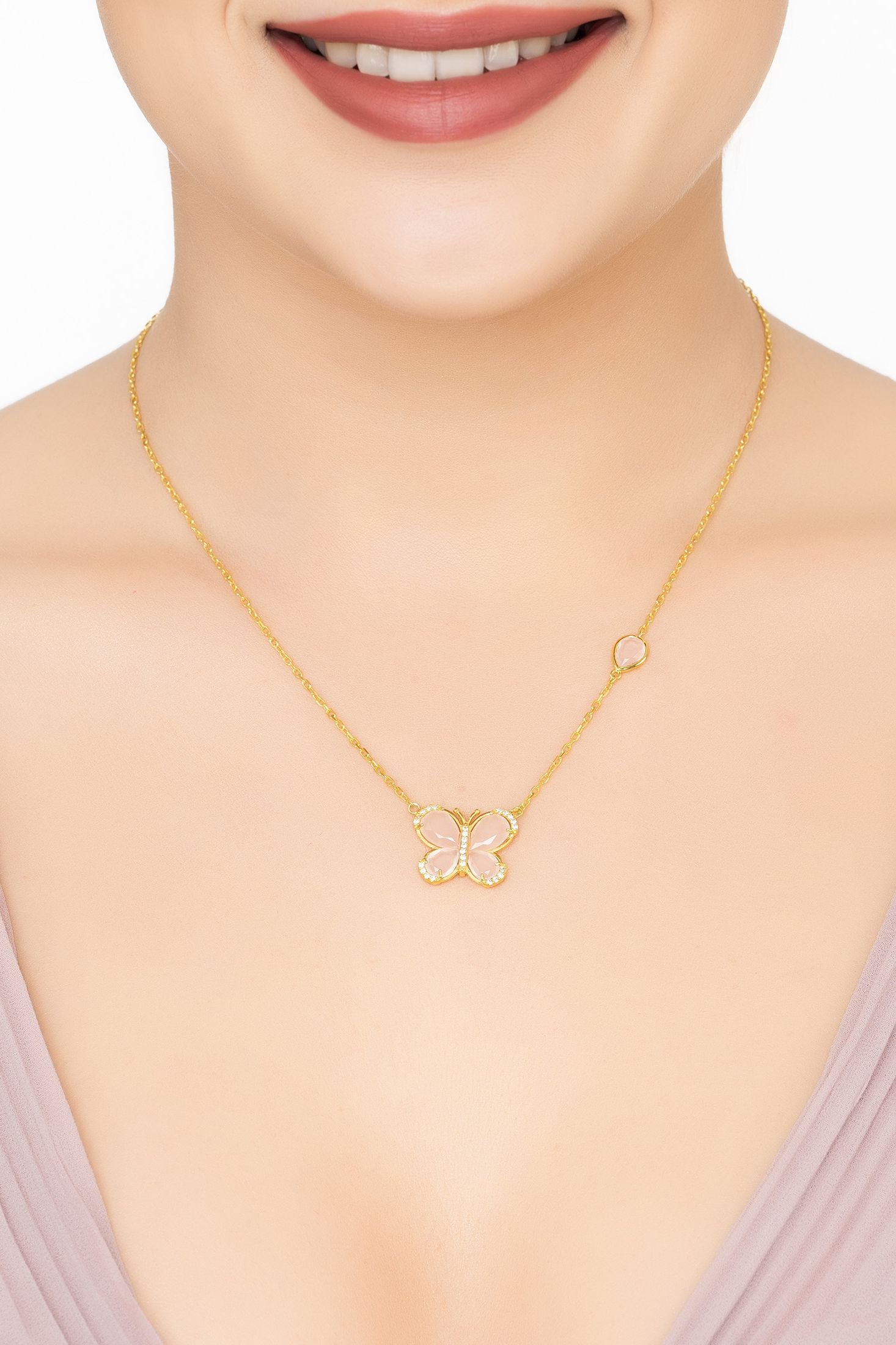 Angled view of Pink Rose Butterfly Pendant Necklace Gold Rose Quartz, showing butterfly design, rose quartz detailing, gold finish and the jewellery profile.