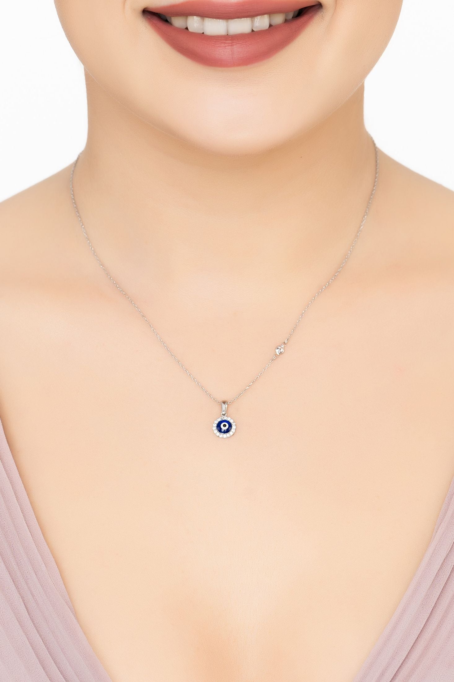 Angled view of Evil Eye Dark Blue Enamel Pendant Necklace Silver, showing evil eye design, silver finish and the jewellery profile.
