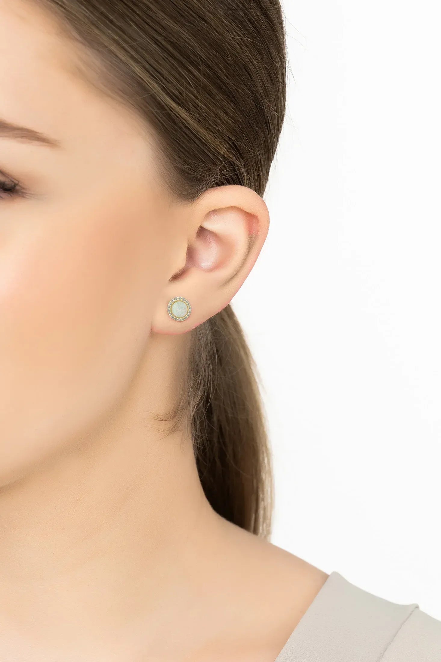 Angled view of Small Sparkling Halo Opal Stud Earrings Gold, showing gold finish and the jewellery profile.