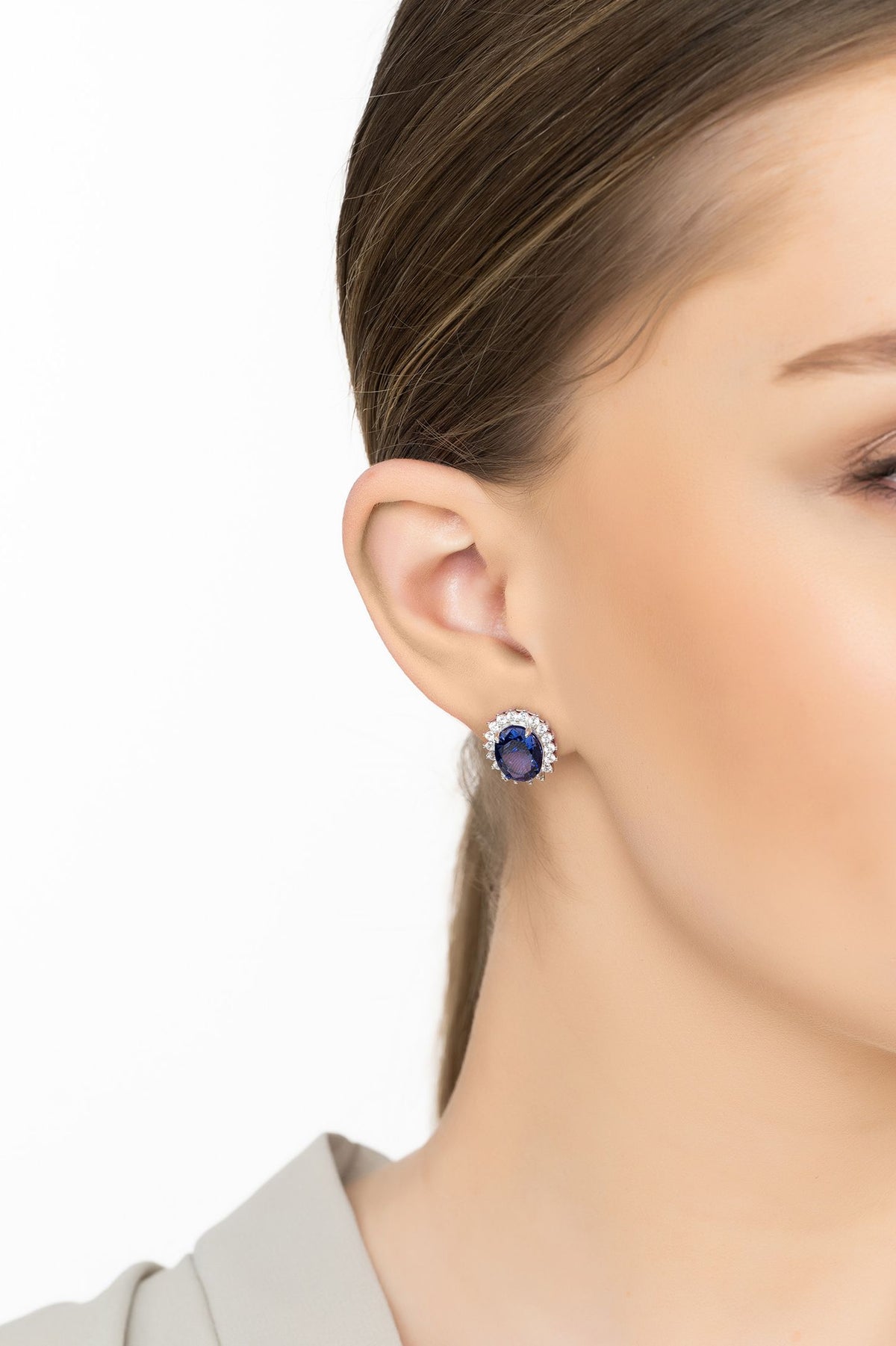 Angled view of Tatiana Oval Tanzanite Stud Earrings Silver, showing tanzanite detailing, silver finish and the jewellery profile.