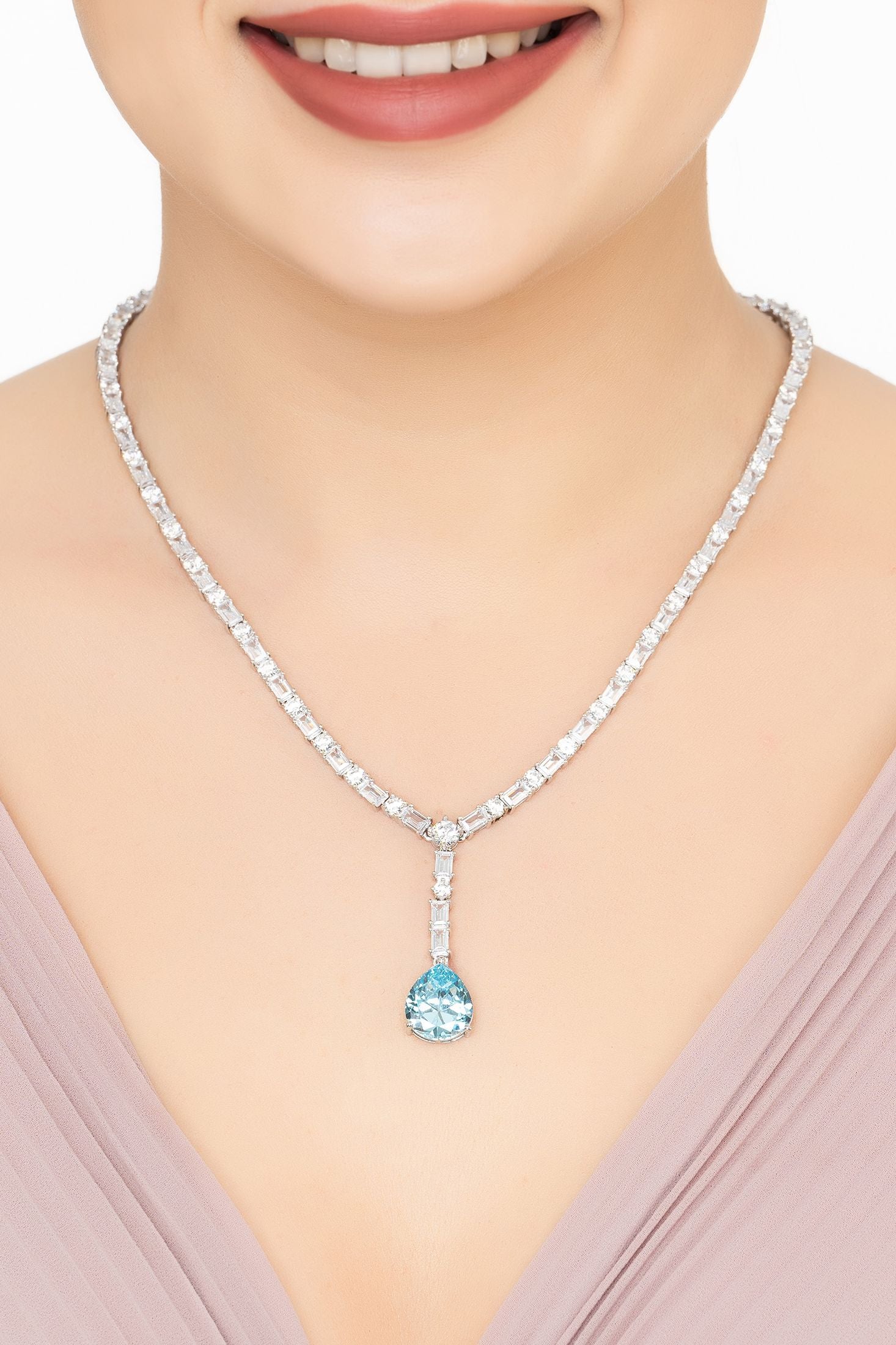 Angled view of Claudette Statement Necklace Silver Blue Topaz, showing blue topaz detailing, silver finish and the jewellery profile.