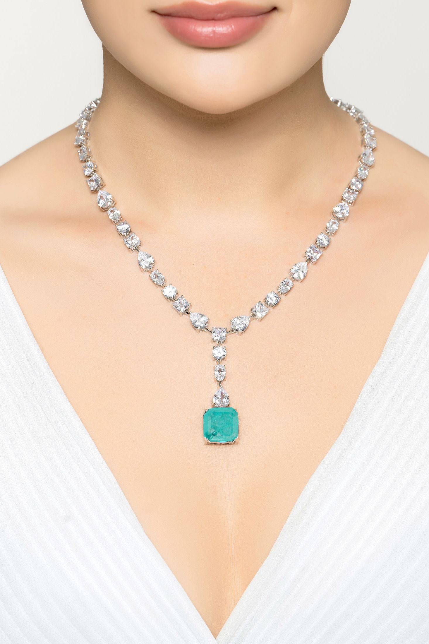 Angled view of Penelope Paraiba Tourmaline Statement Necklace Silver, showing silver finish and the jewellery profile.