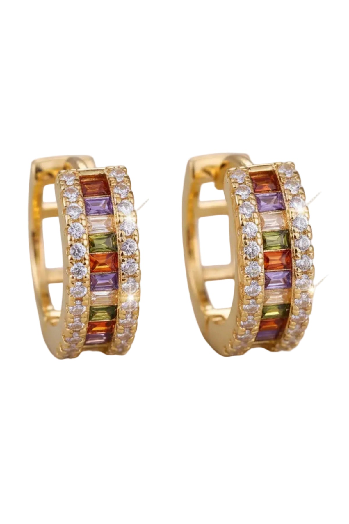 A pair of gold huggie hoop earrings with colorful gemstone accents and clear pavé stones, displayed on a soft cream jewelry cushion.
