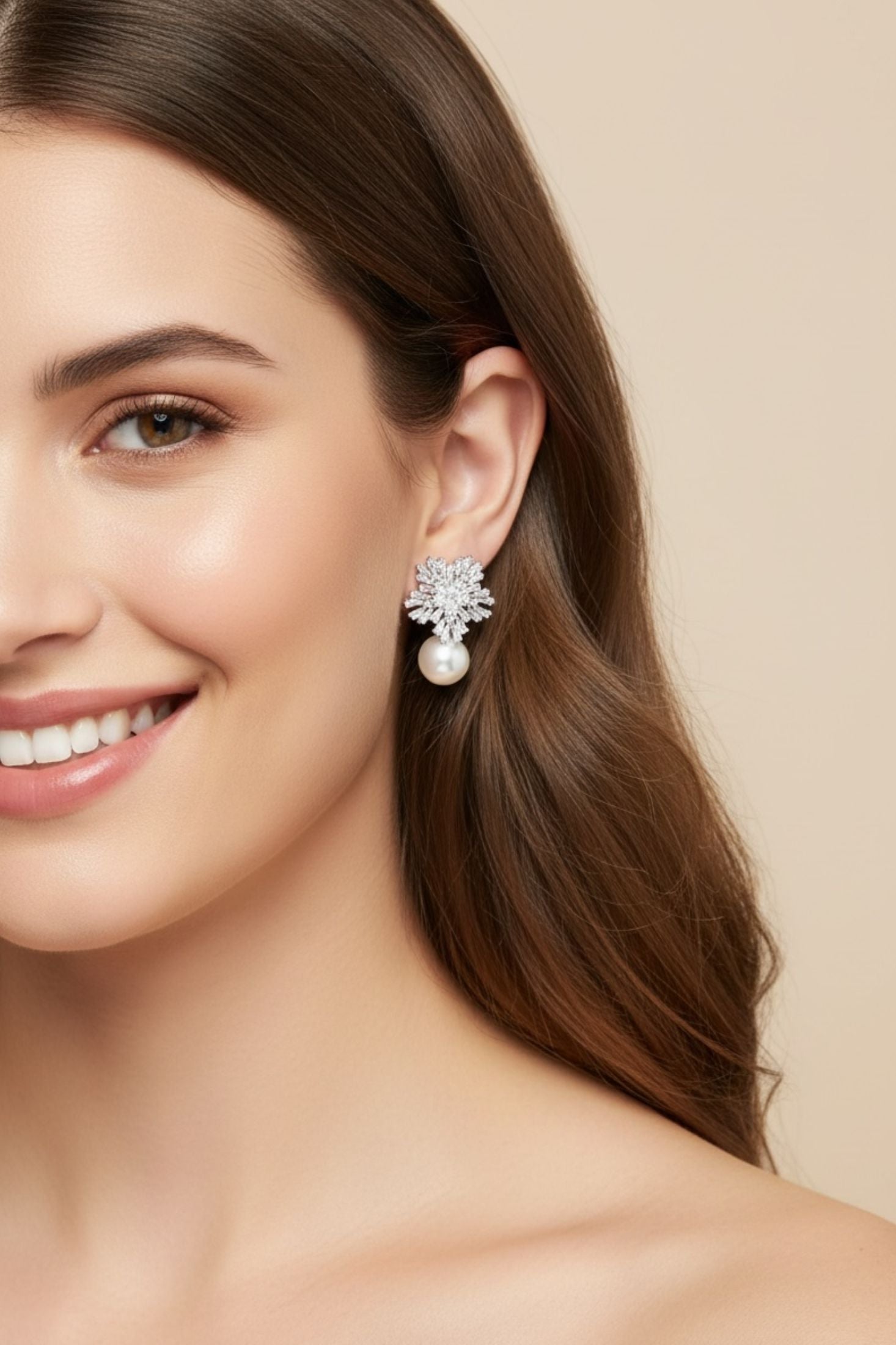 Silver star shaped earrings with a pearl worn by a model.
