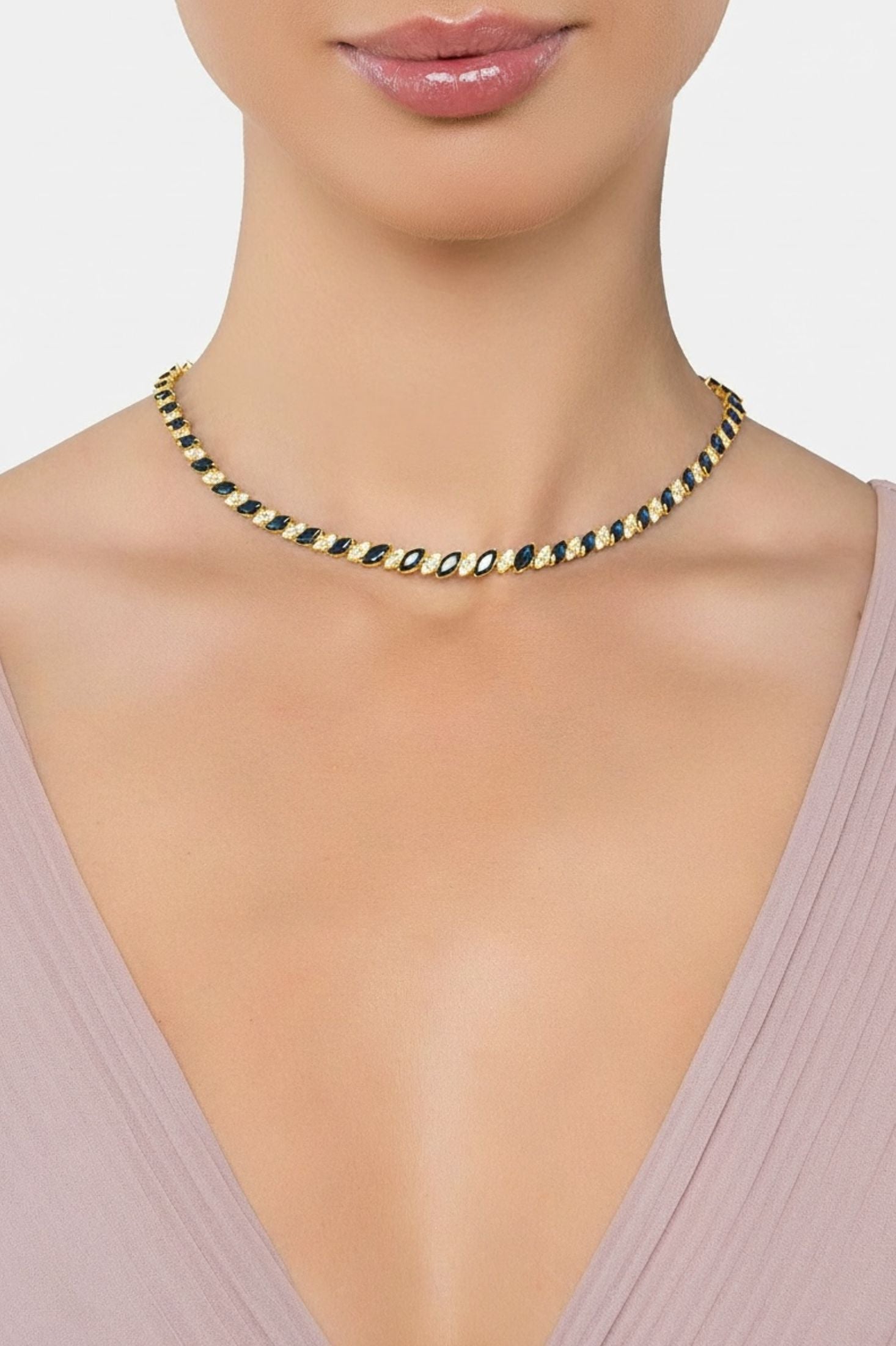 Gold and blue statement necklace worn by a model