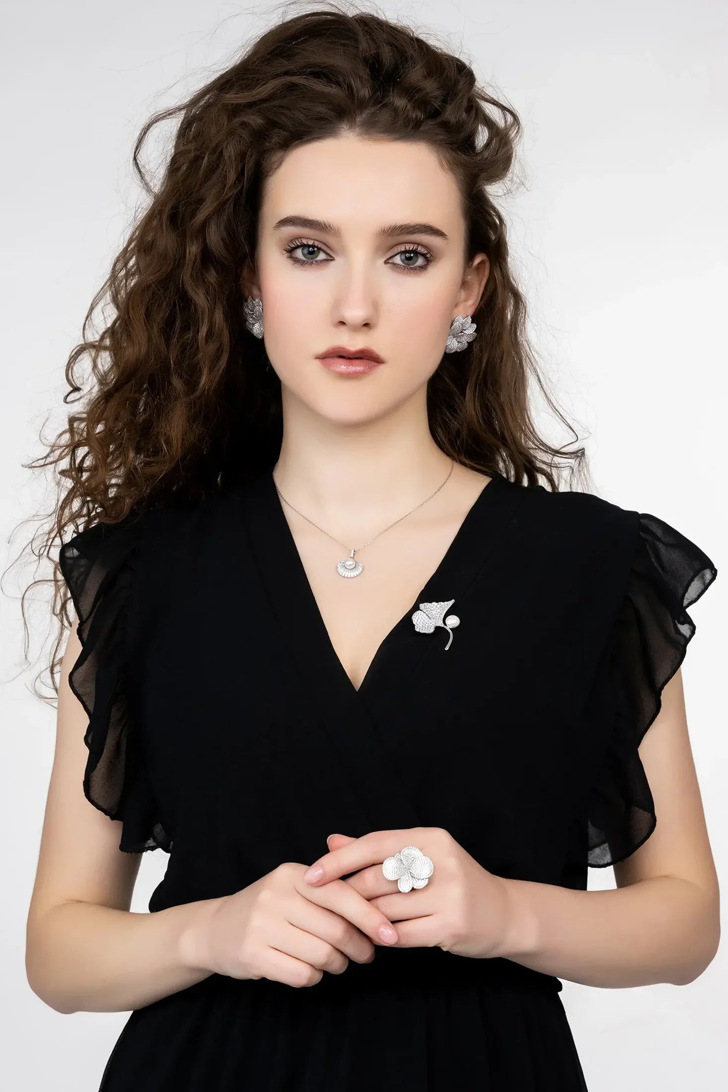 Angled view of Ginkgo Leaf And Pearl Brooch Silver, showing leaf design, pearl detailing, silver finish and the jewellery profile.