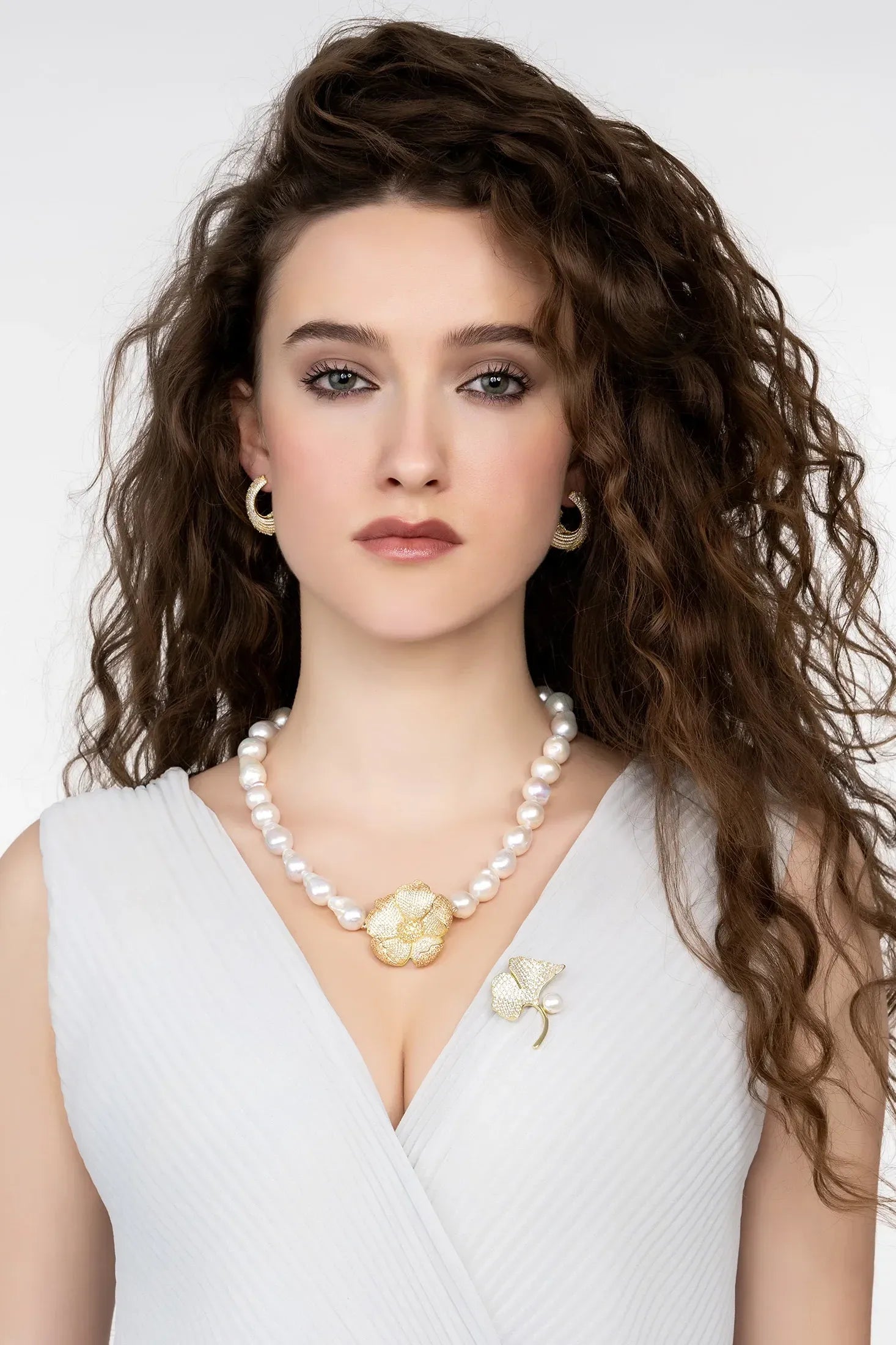 Angled view of Ginkgo Leaf And Pearl Brooch Gold, showing leaf design, pearl detailing, gold finish and the jewellery profile.