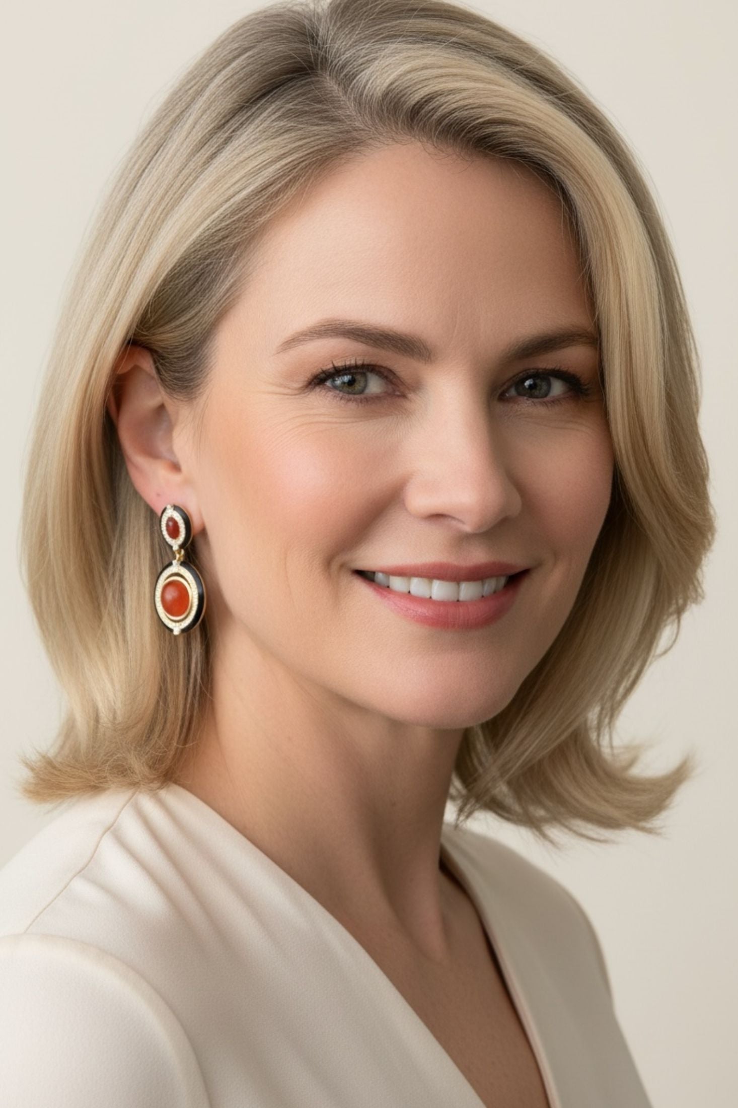 Woman wearing earrings with a neutral background
