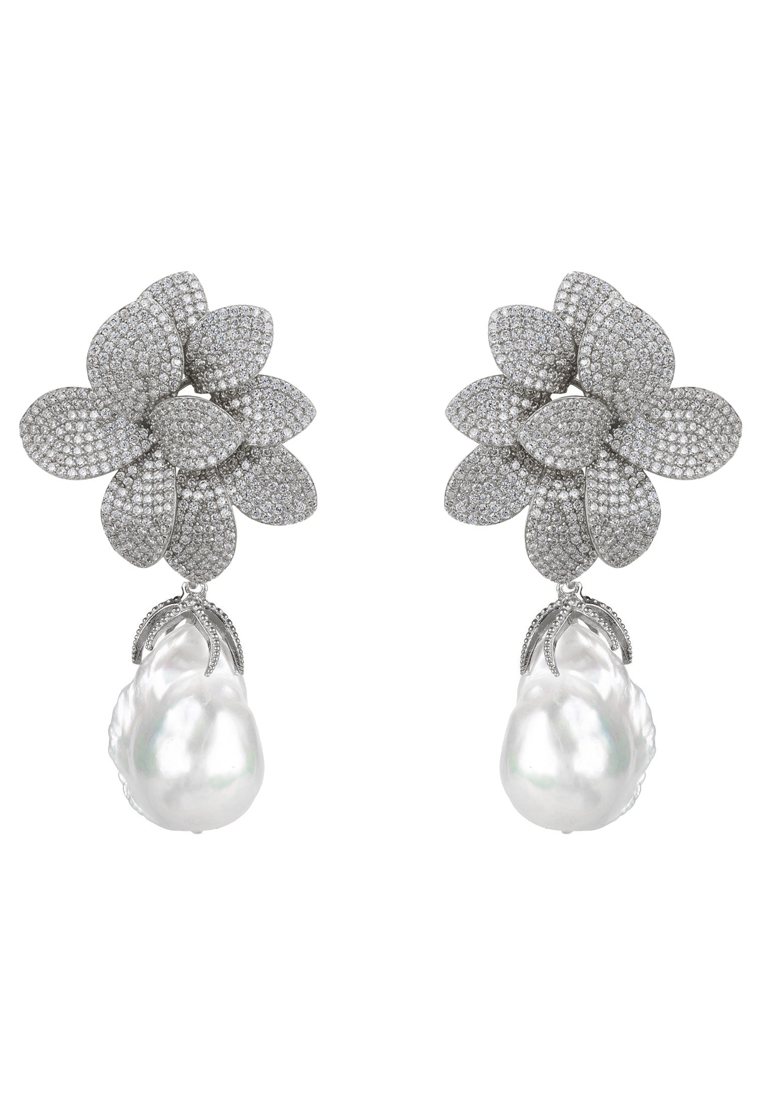 Pair of floral earrings with pearl drops on a white background