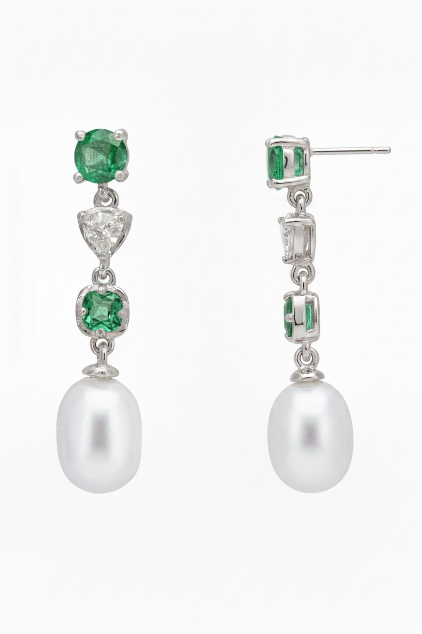 Angled view of Pearl Whisper Drop Earrings Colombian Emerald Silver, showing pearl and emerald detailing, silver finish and the jewellery profile.