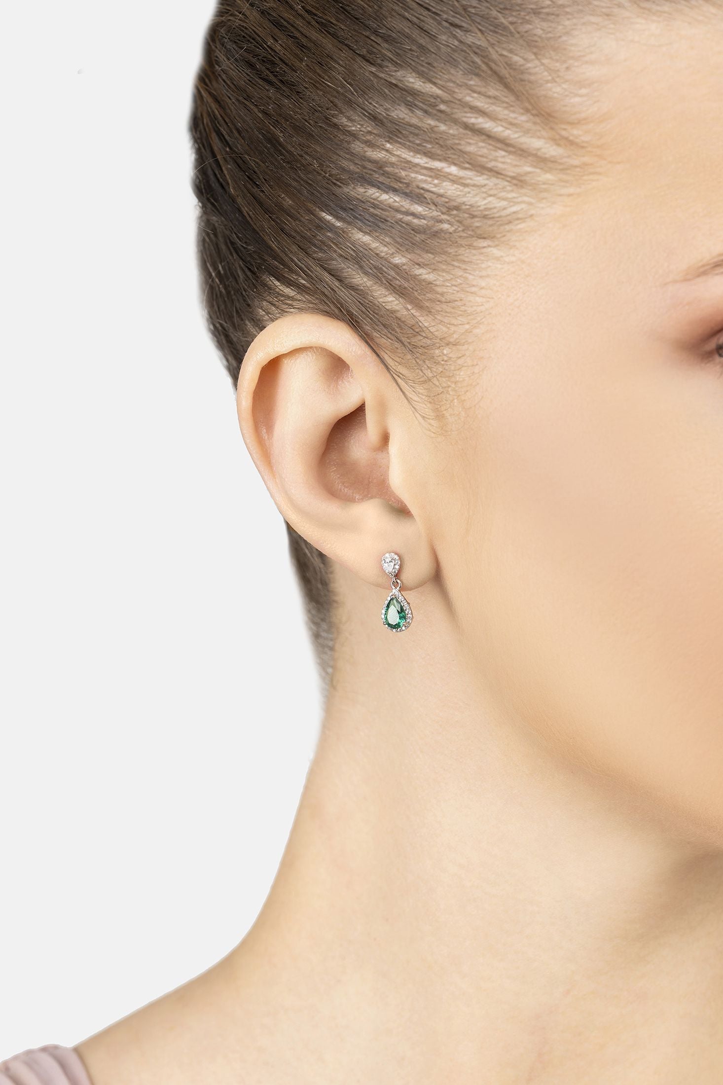 Angled view of Phillippa Drop Earrings Emerald Silver, showing emerald detailing, silver finish and the jewellery profile.