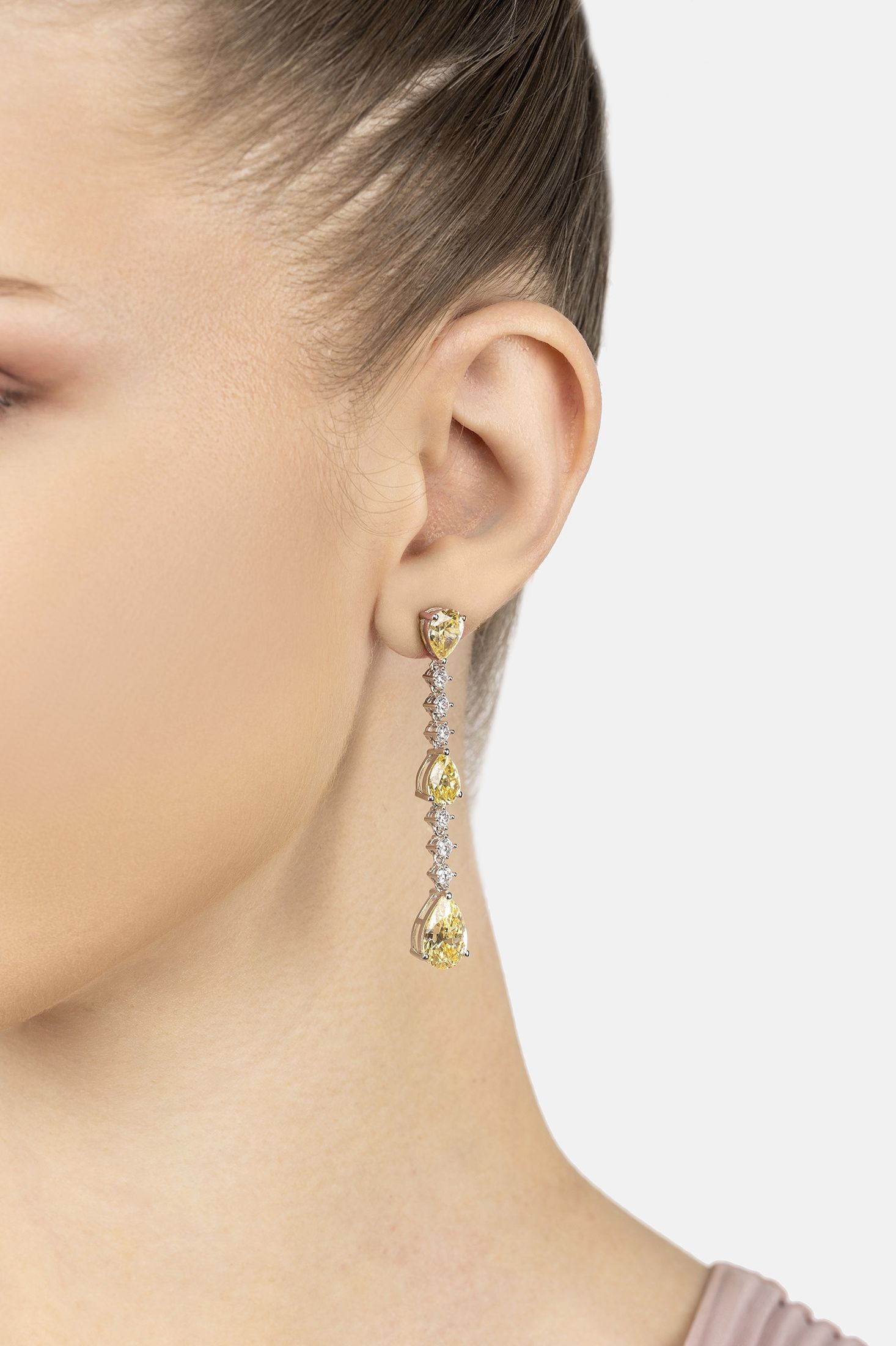 Angled view of Elizabeth Drop Earrings Yellow Topaz Silver, showing silver finish and the jewellery profile.