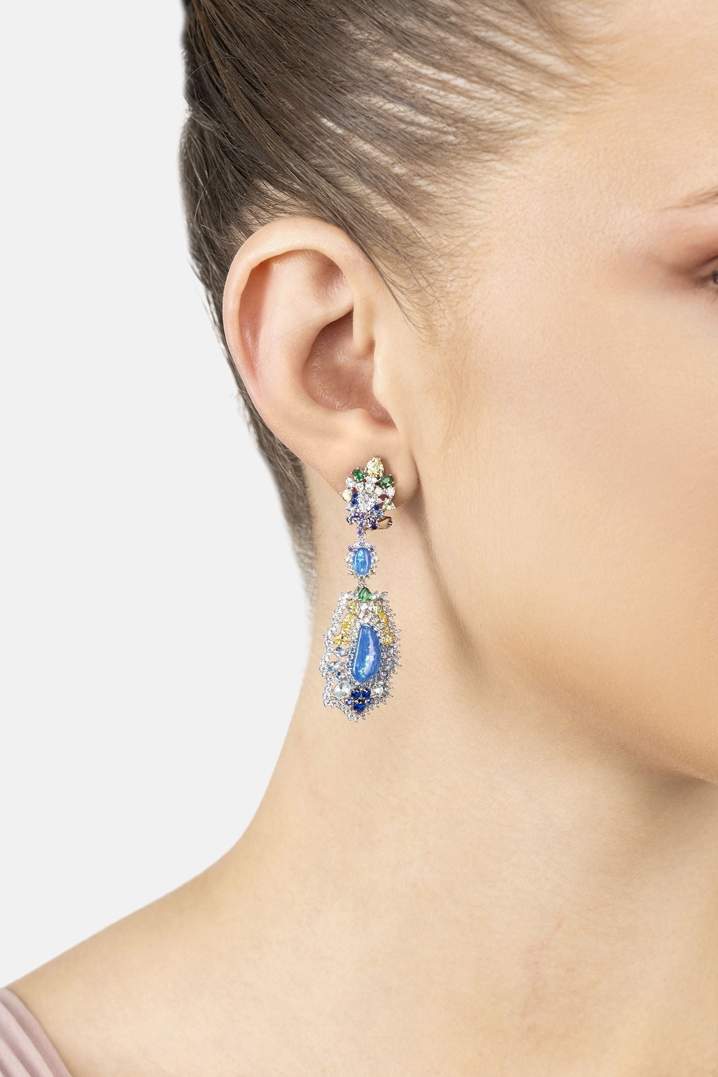 Angled view of Frida Blue Opal Rainbow Drop Earrings Silver, showing bow design, silver finish and the jewellery profile.