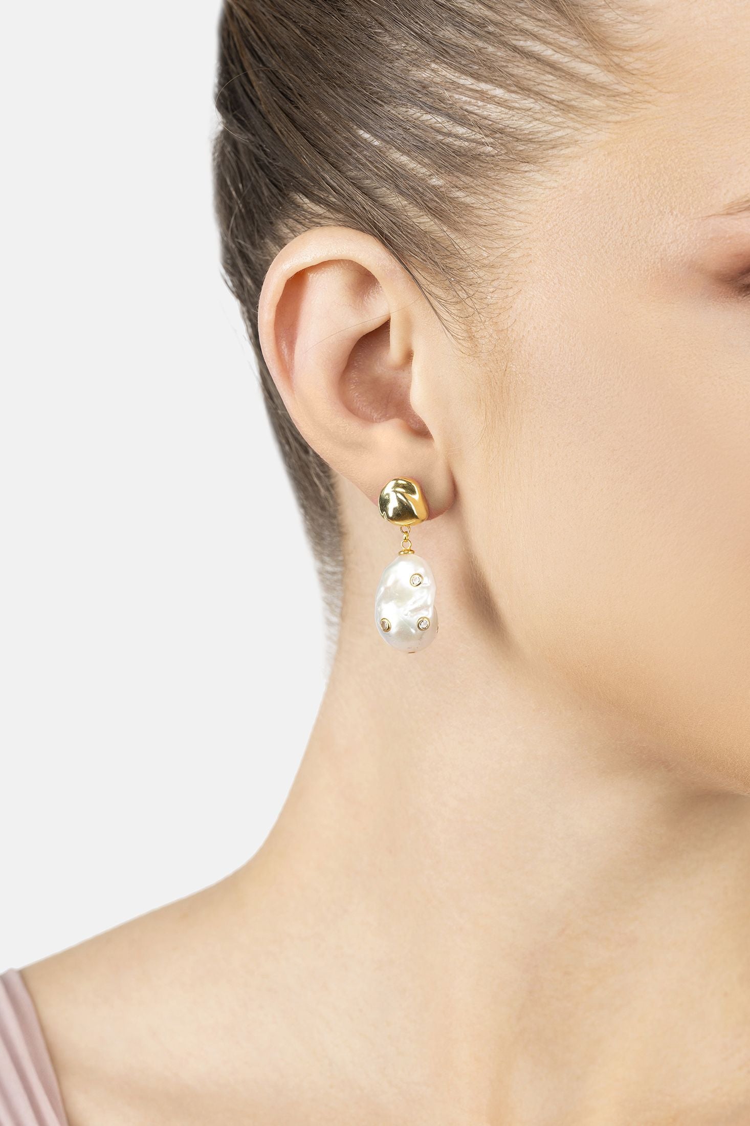 Angled view of Polka Dot Baroque Pearl Drop Earrings Gold Cz, showing baroque pearl and pearl detailing, gold finish and the jewellery profile.