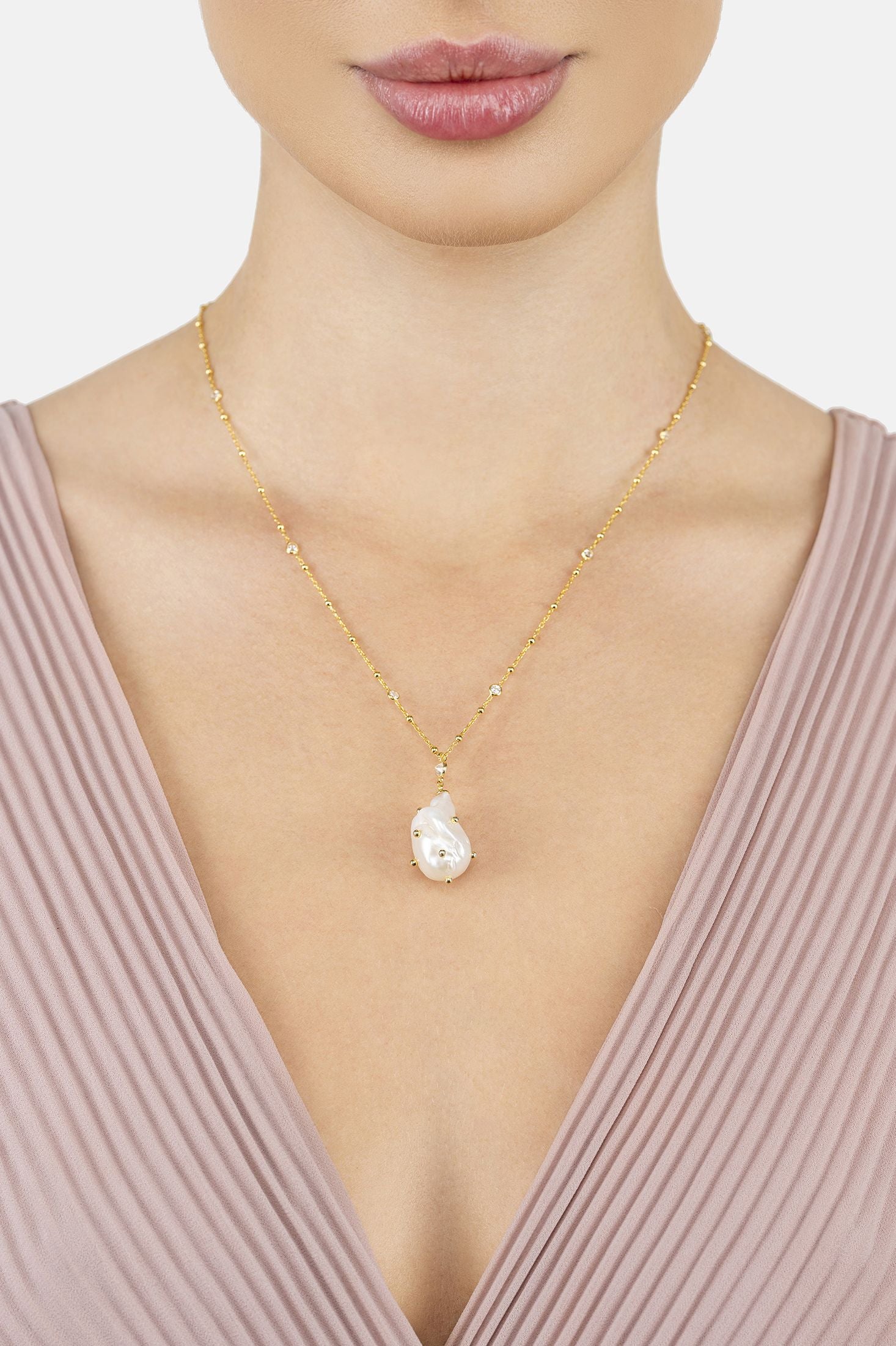 Angled view of Polka Dot Baroque Pearl Pendant Necklace Gold Cz, showing baroque pearl and pearl detailing, gold finish and the jewellery profile.