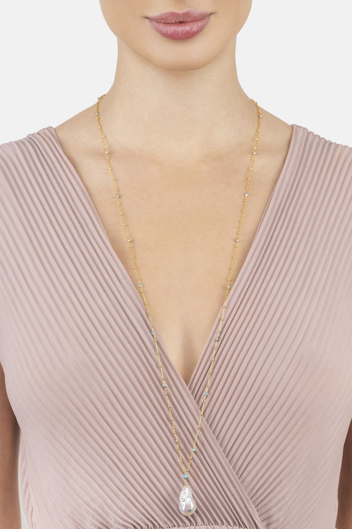 Angled view of Polka Dot Baroque Pearl Long Necklace Gold Turquoise, showing baroque pearl and pearl detailing, gold finish and the jewellery profile.
