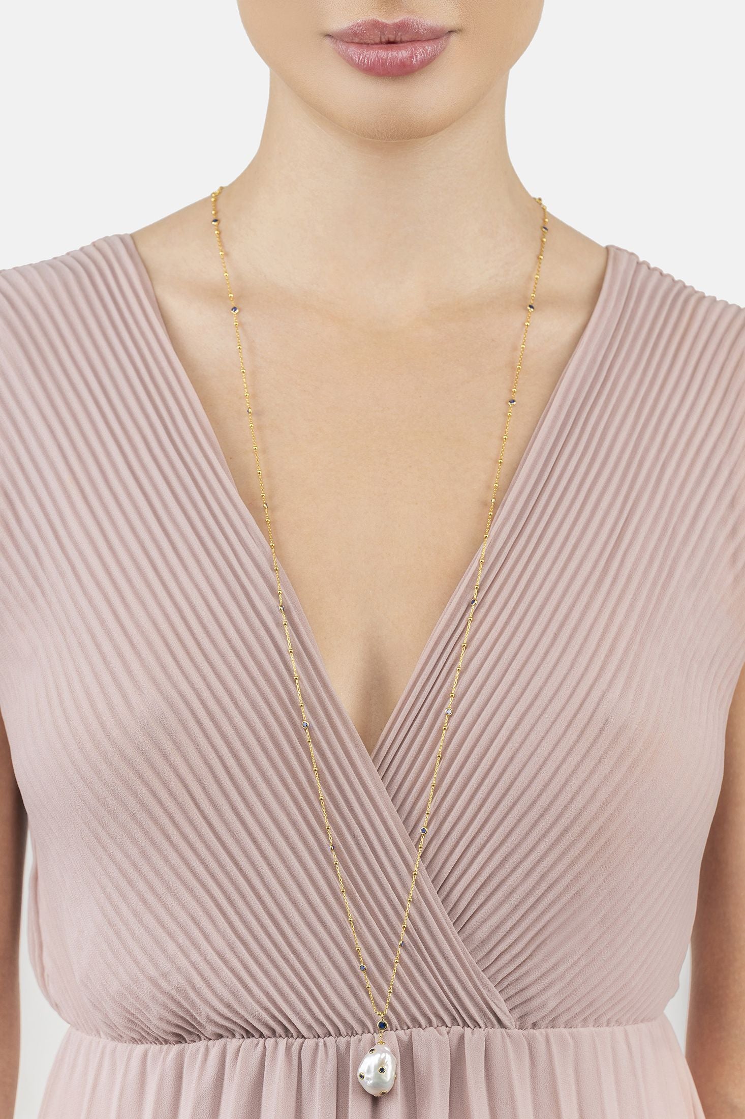 Angled view of Polka Dot Baroque Pearl Long Necklace Gold Sapphire, showing baroque pearl and pearl detailing, gold finish and the jewellery profile.