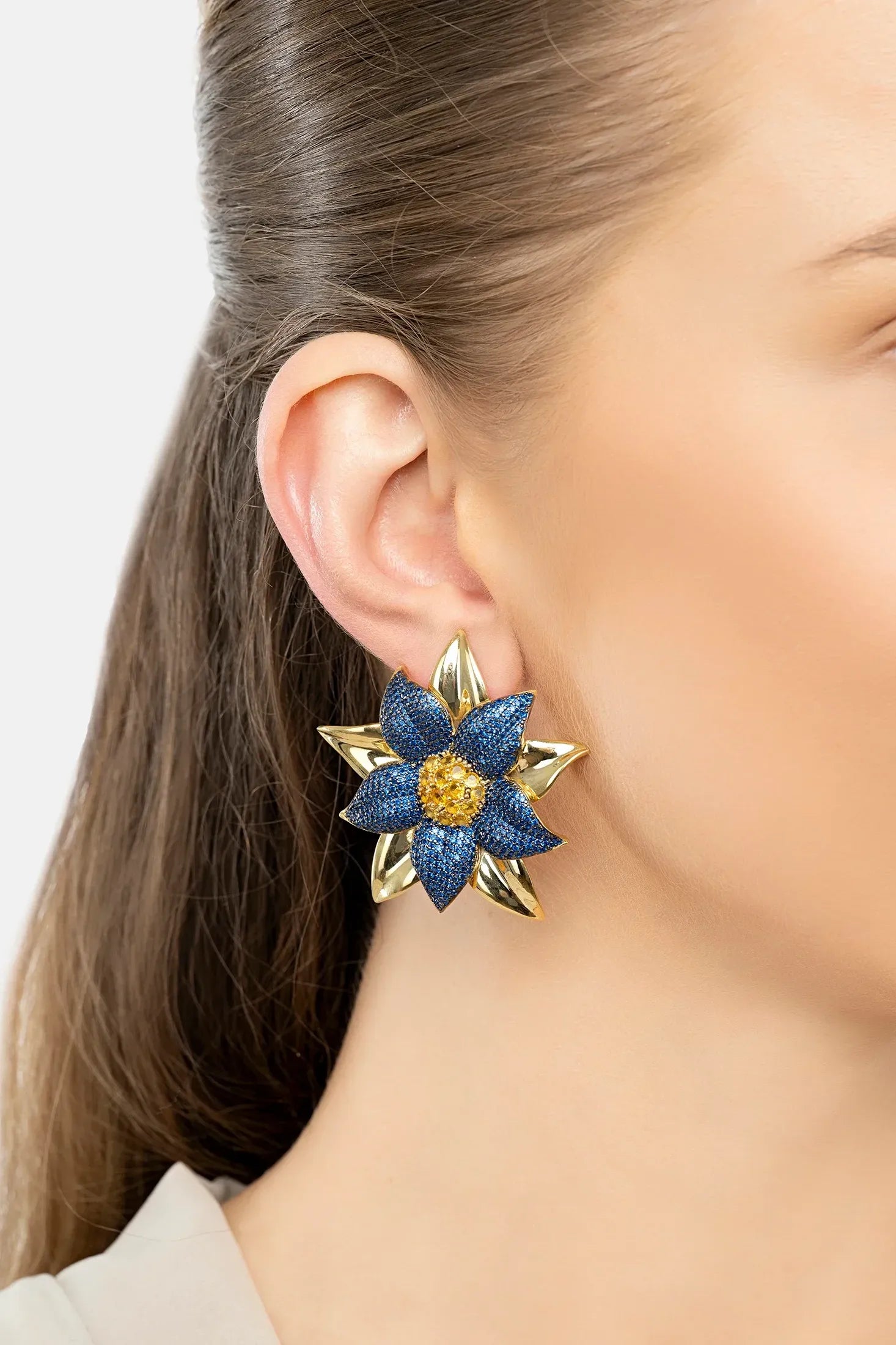 The earring worn by a model.