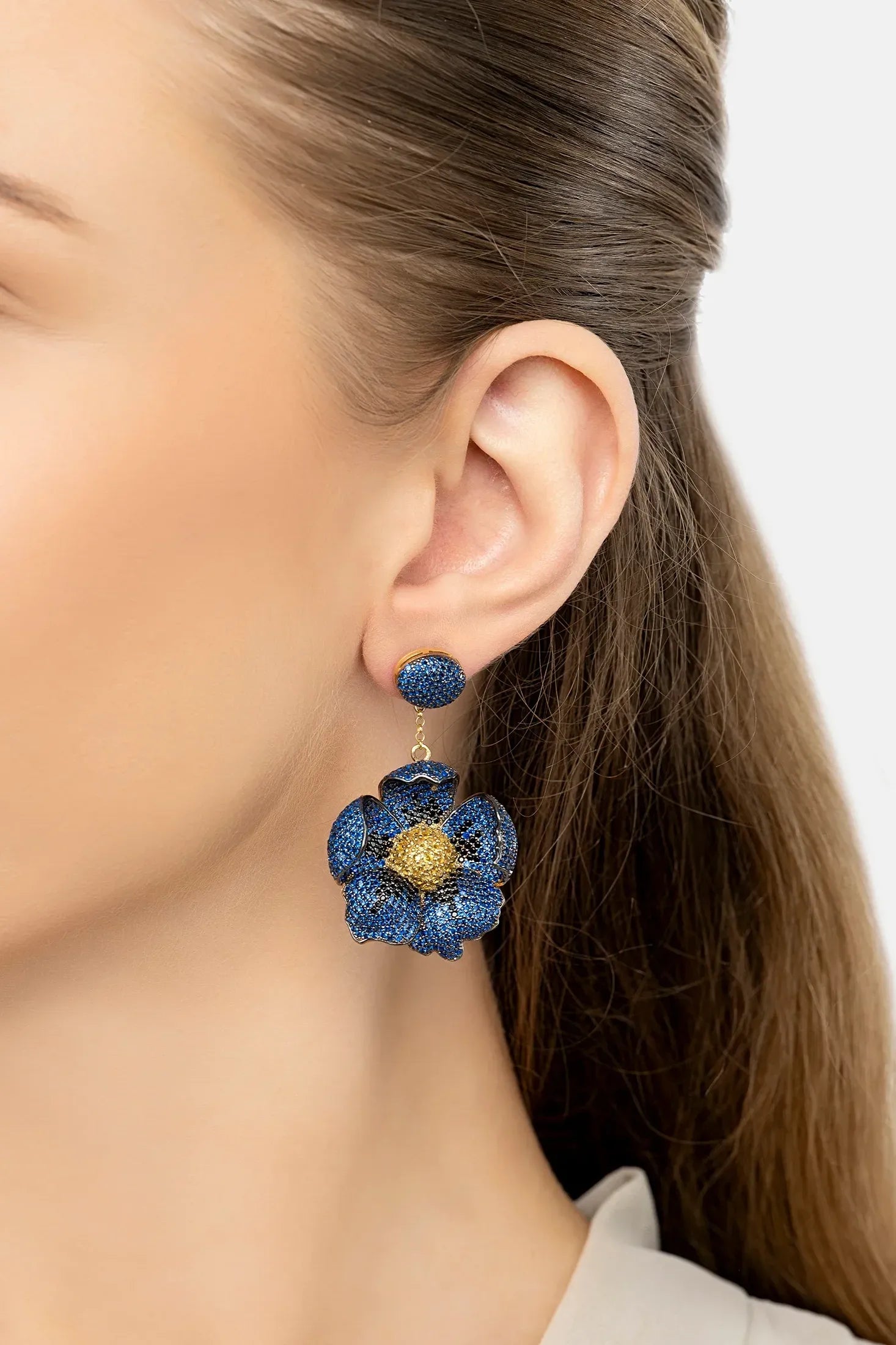 The earring worn by a model.