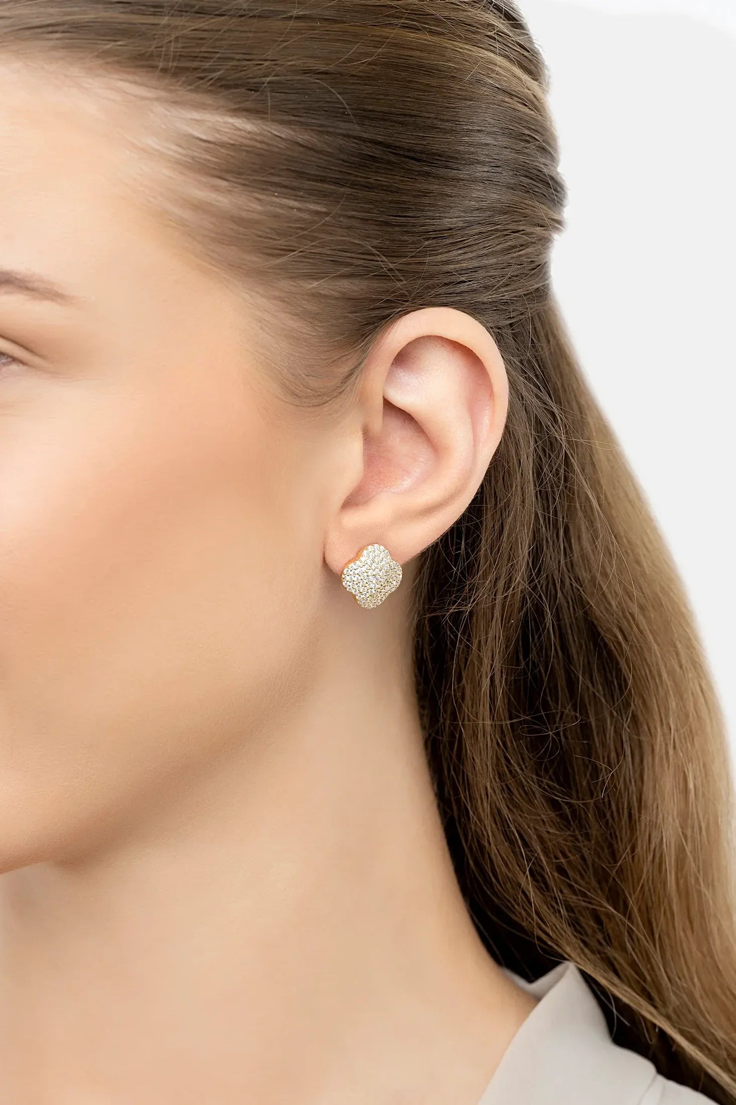 The earring worn by a model.
