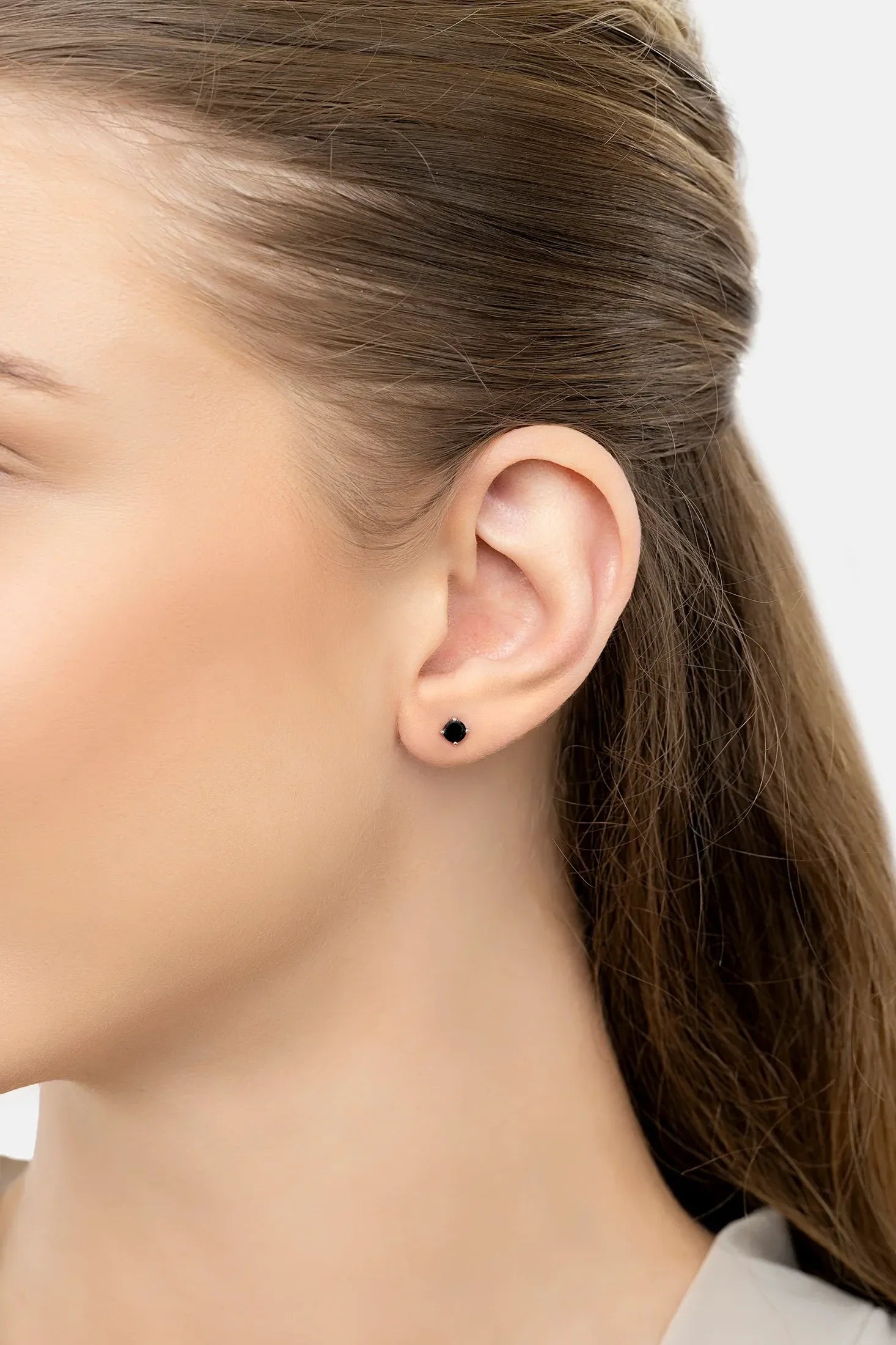 The earring worn by a model.