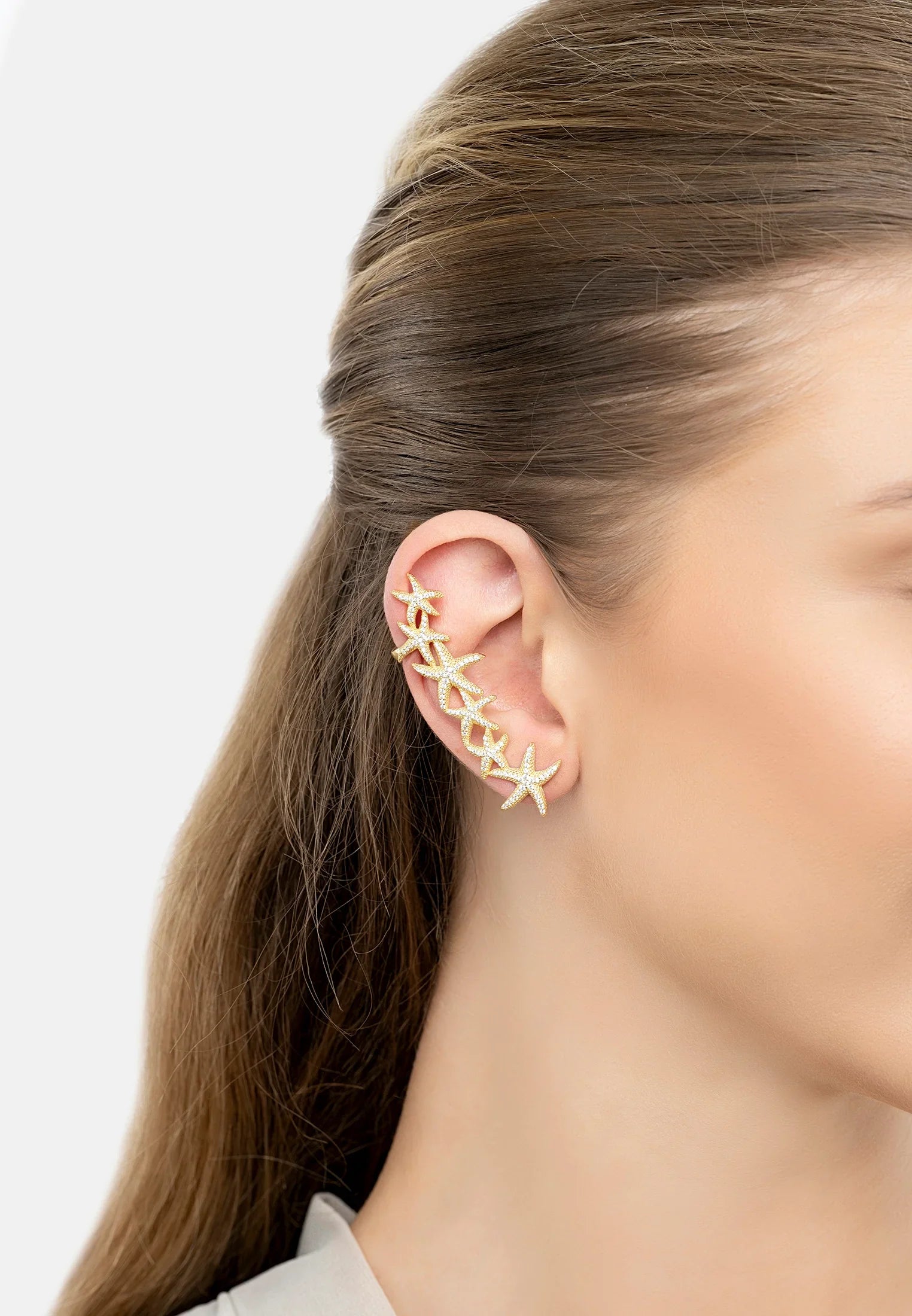 The earring worn by a model.