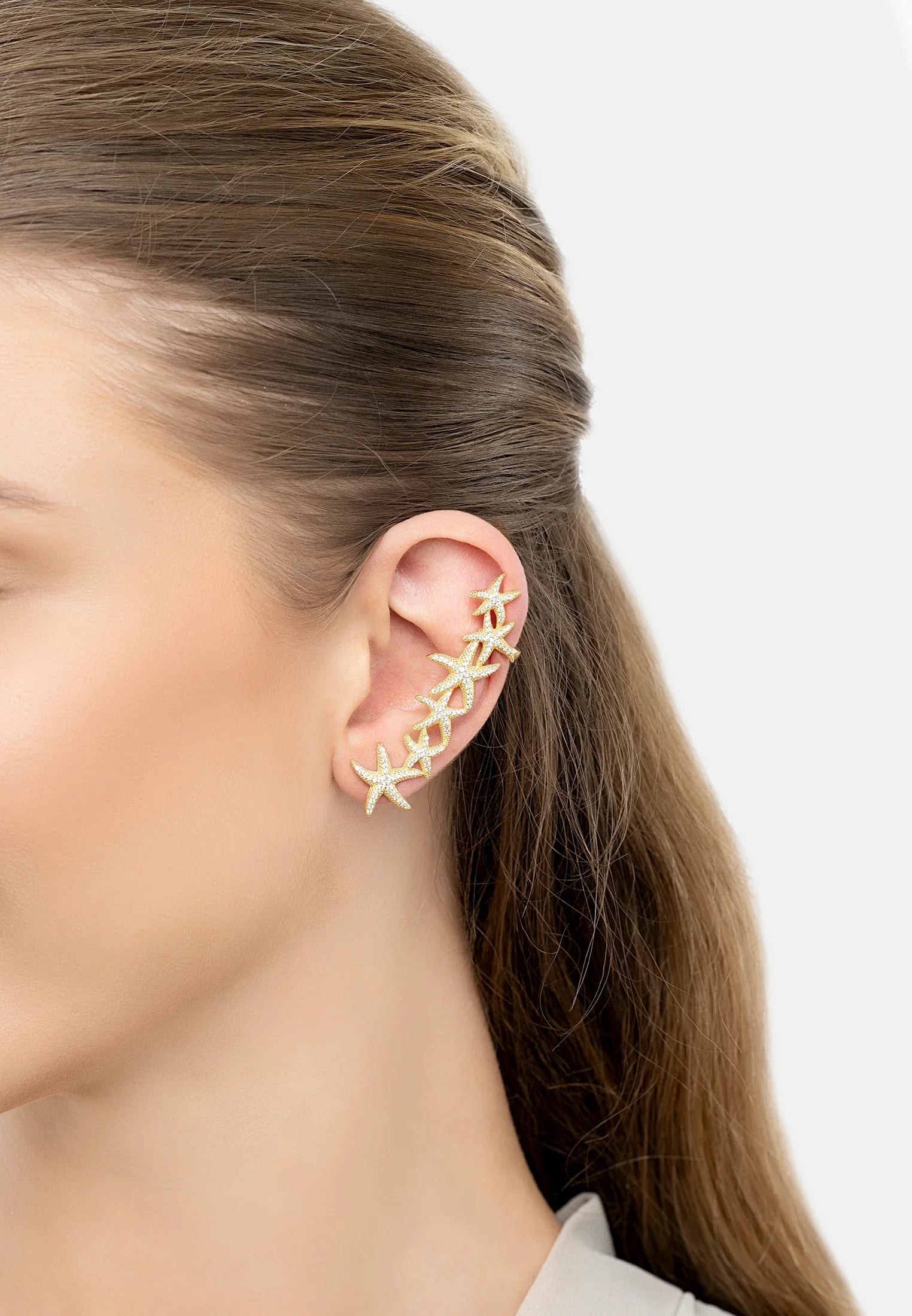 The earring worn by a model.