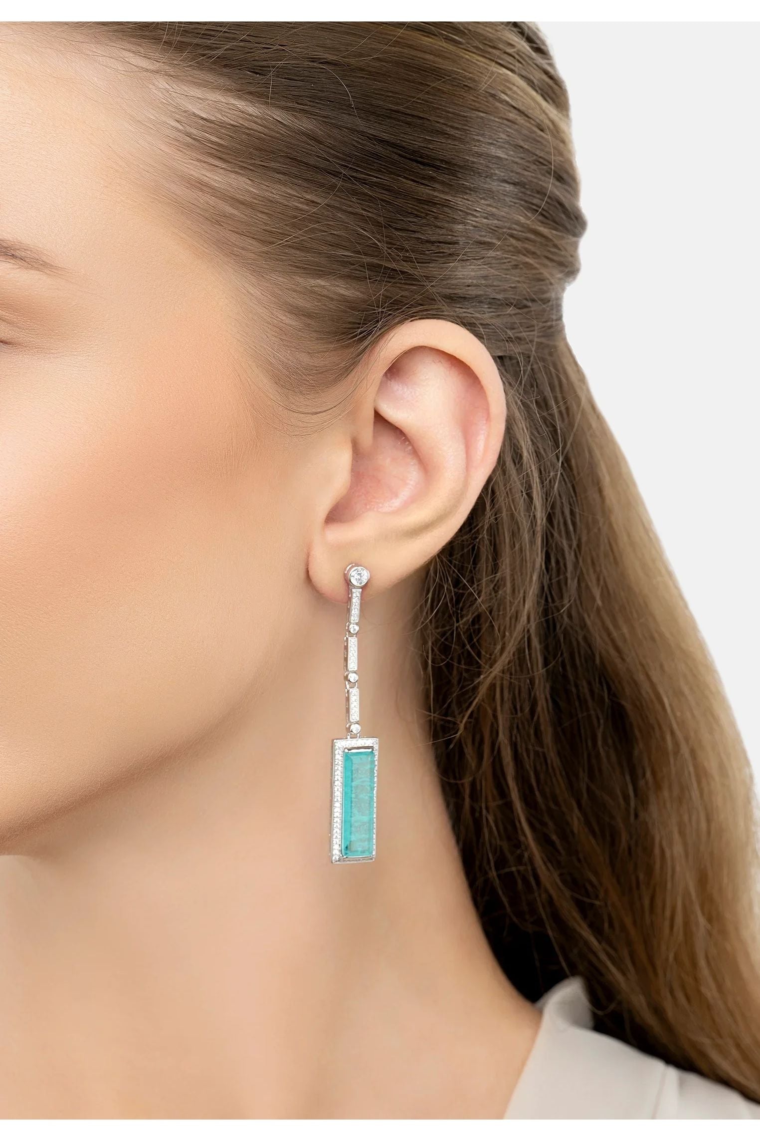 The earring worn by a model.