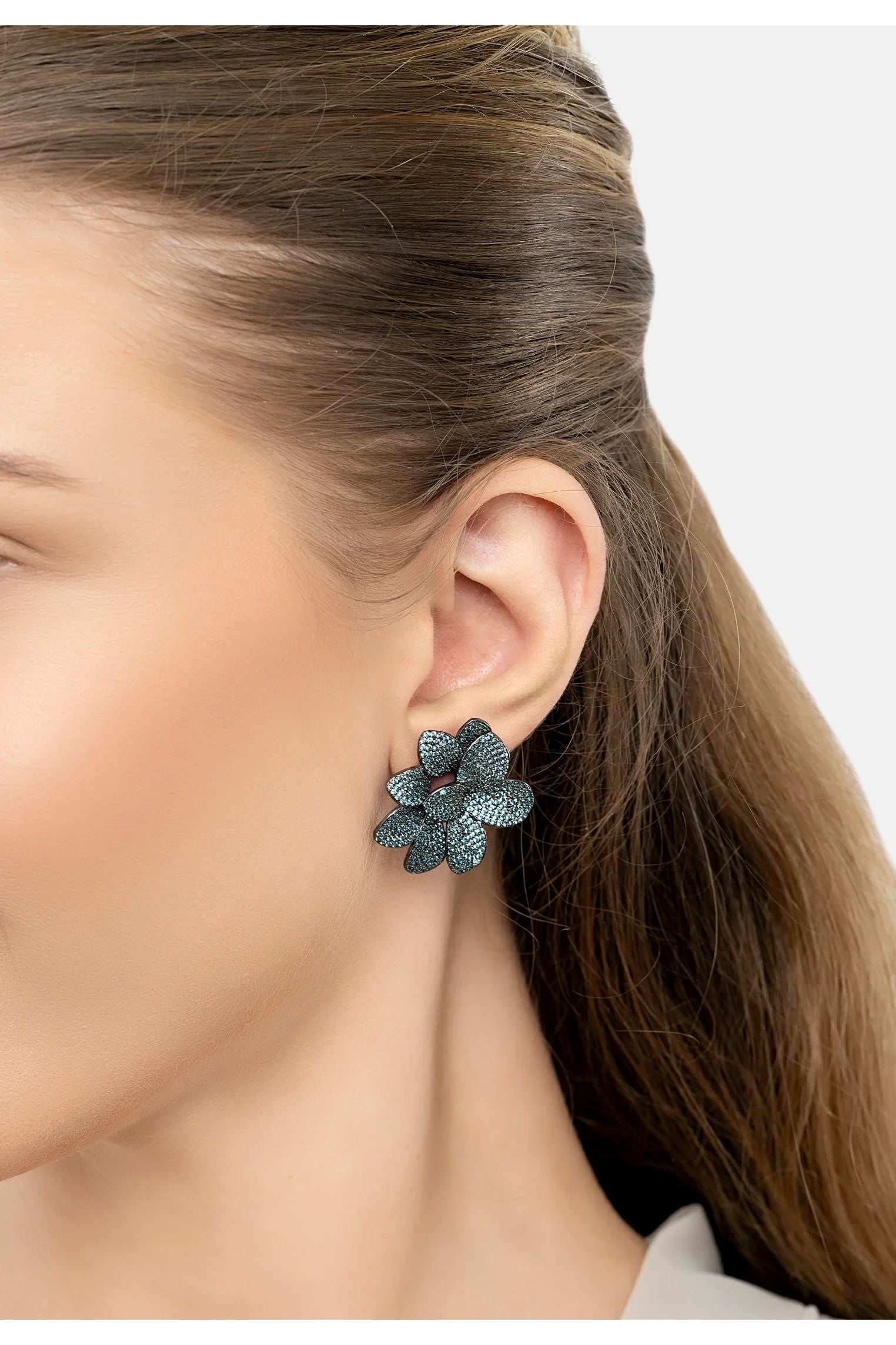The earring worn by a model.