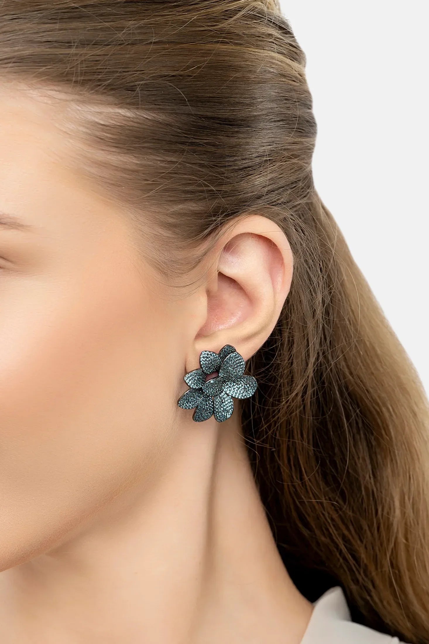The earring worn by a model.