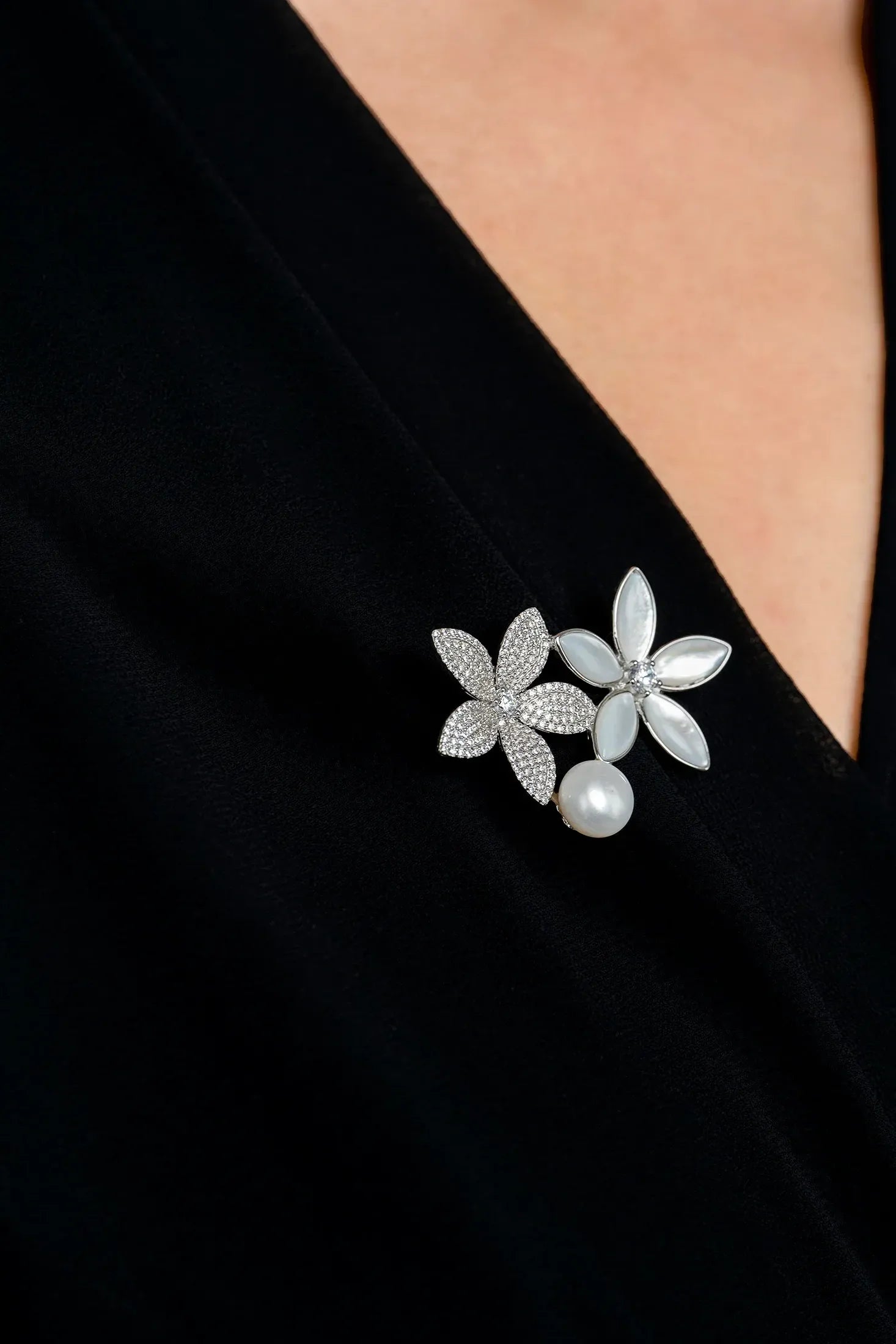 The brooch worn by a model.