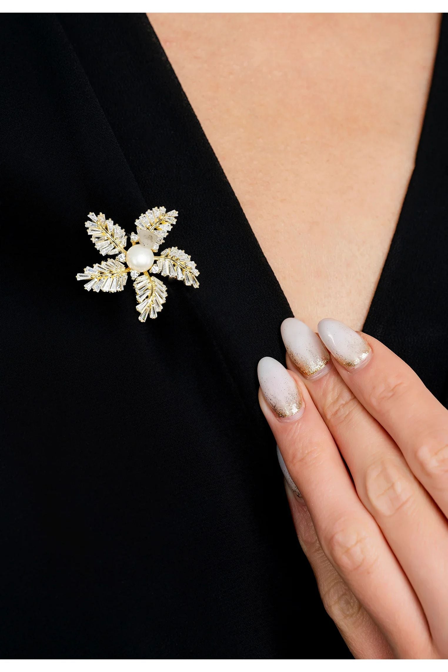 The brooch worn by a model.