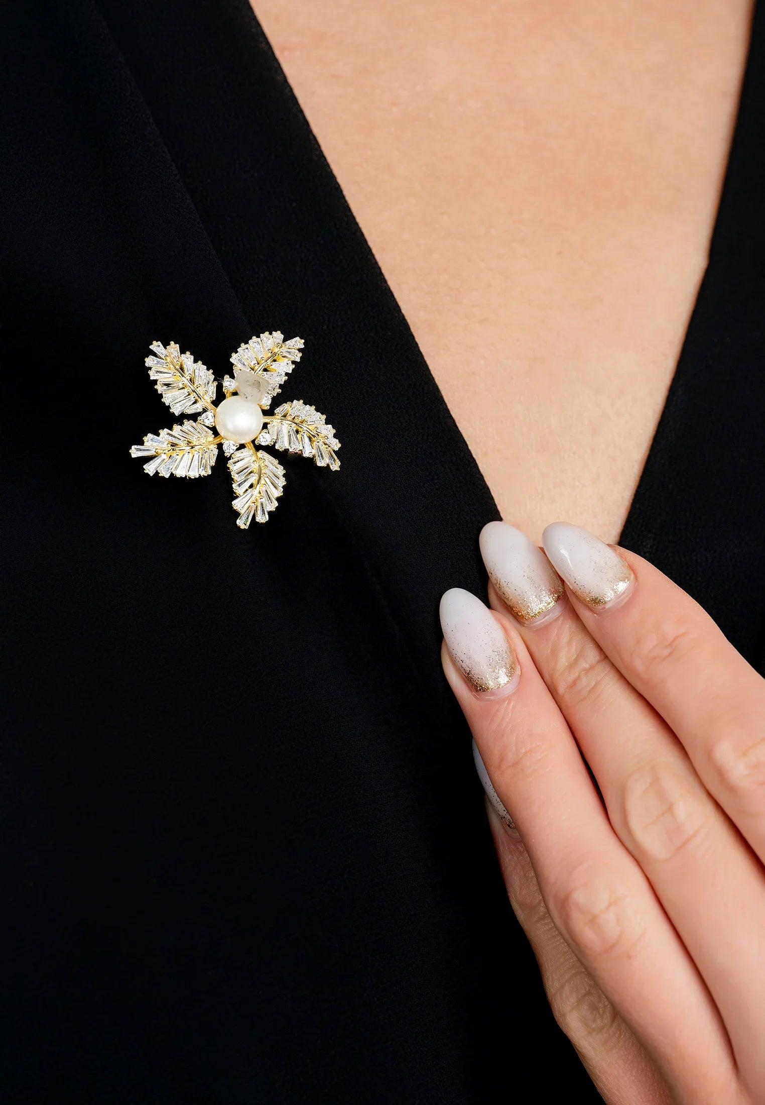 The brooch worn by a model.
