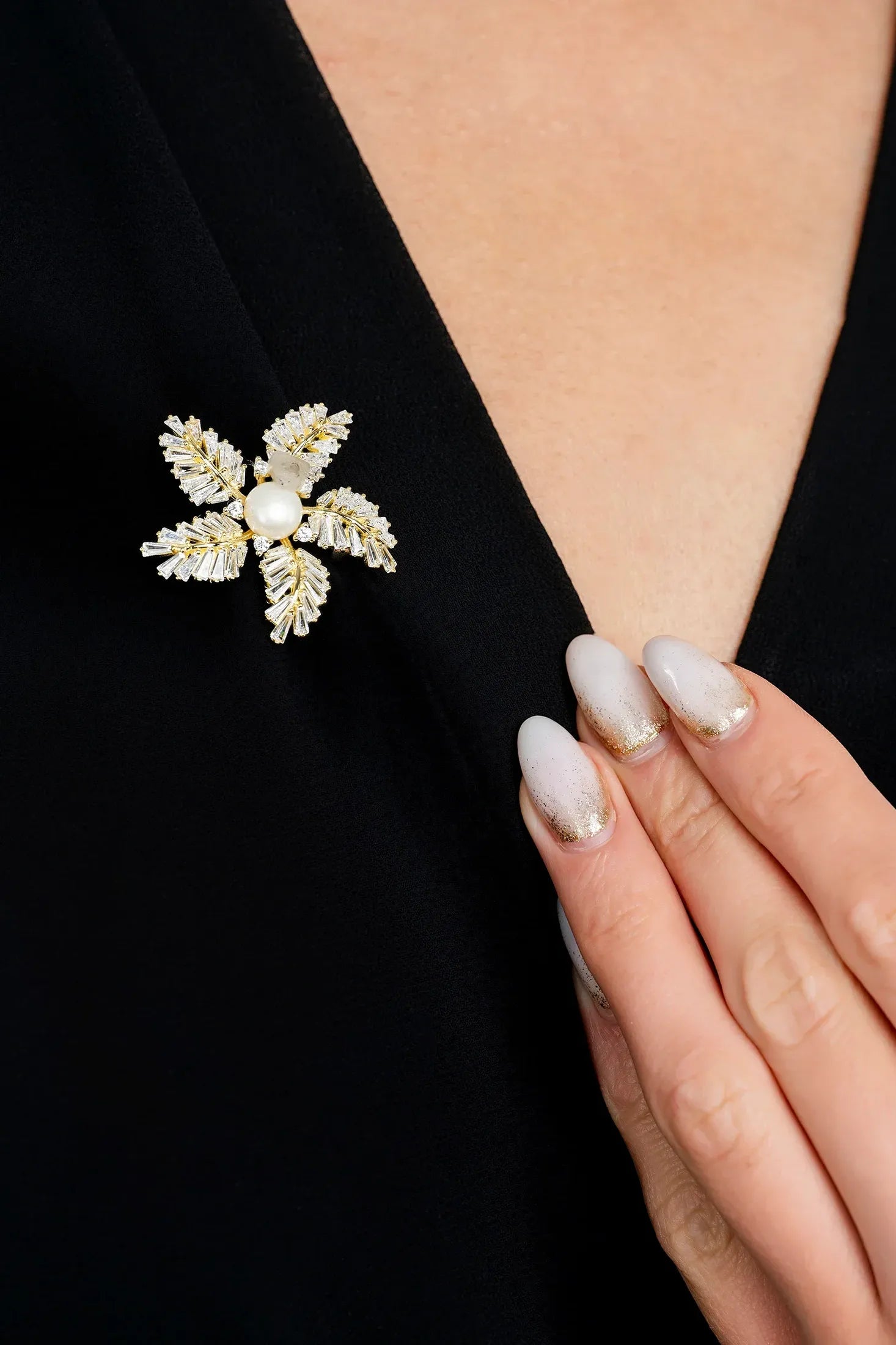 The brooch worn by a model.