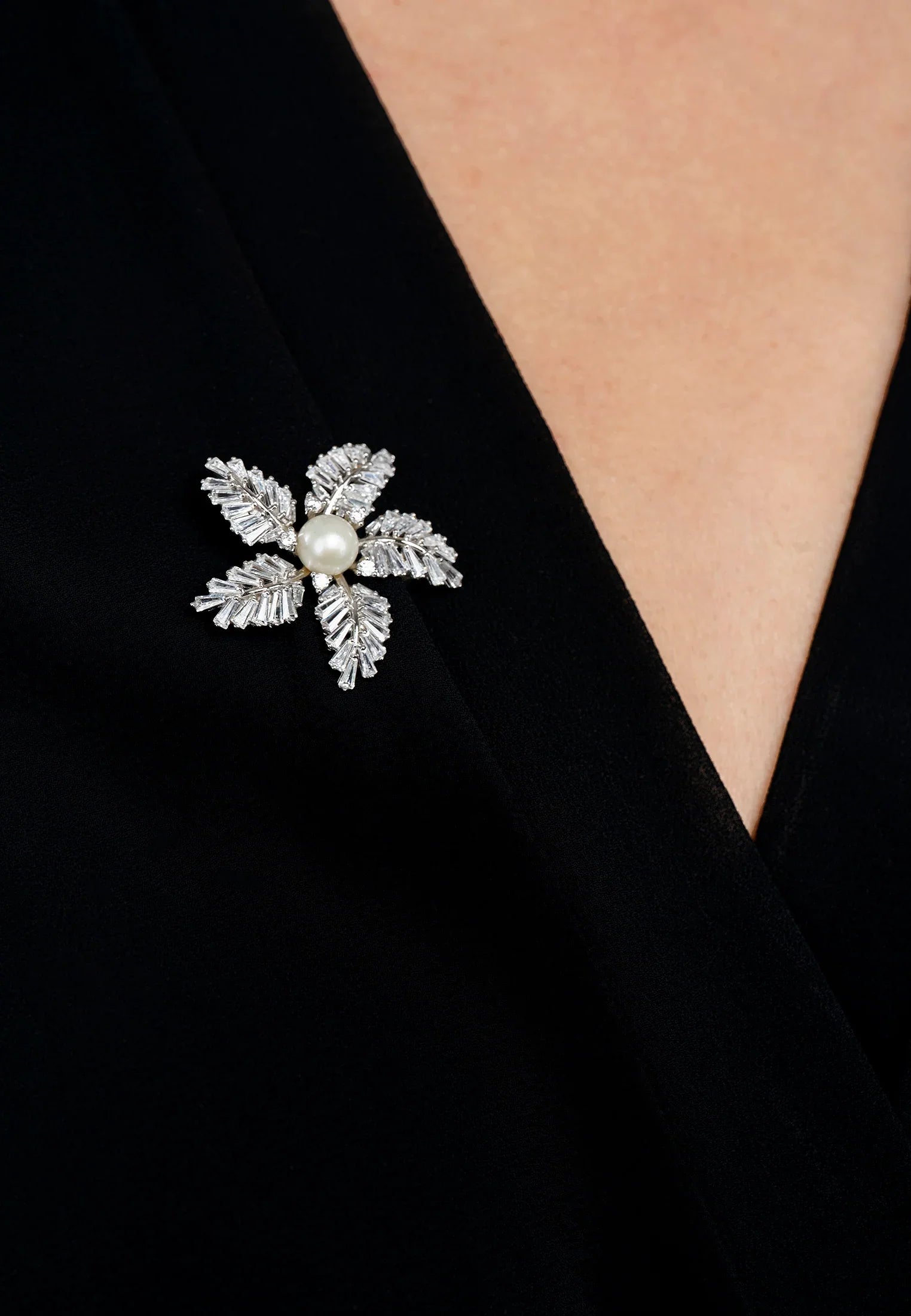 The brooch worn by a model.