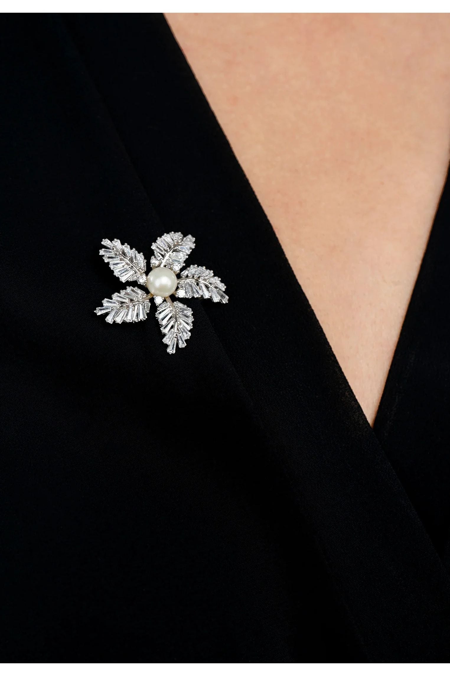The brooch worn by a model.