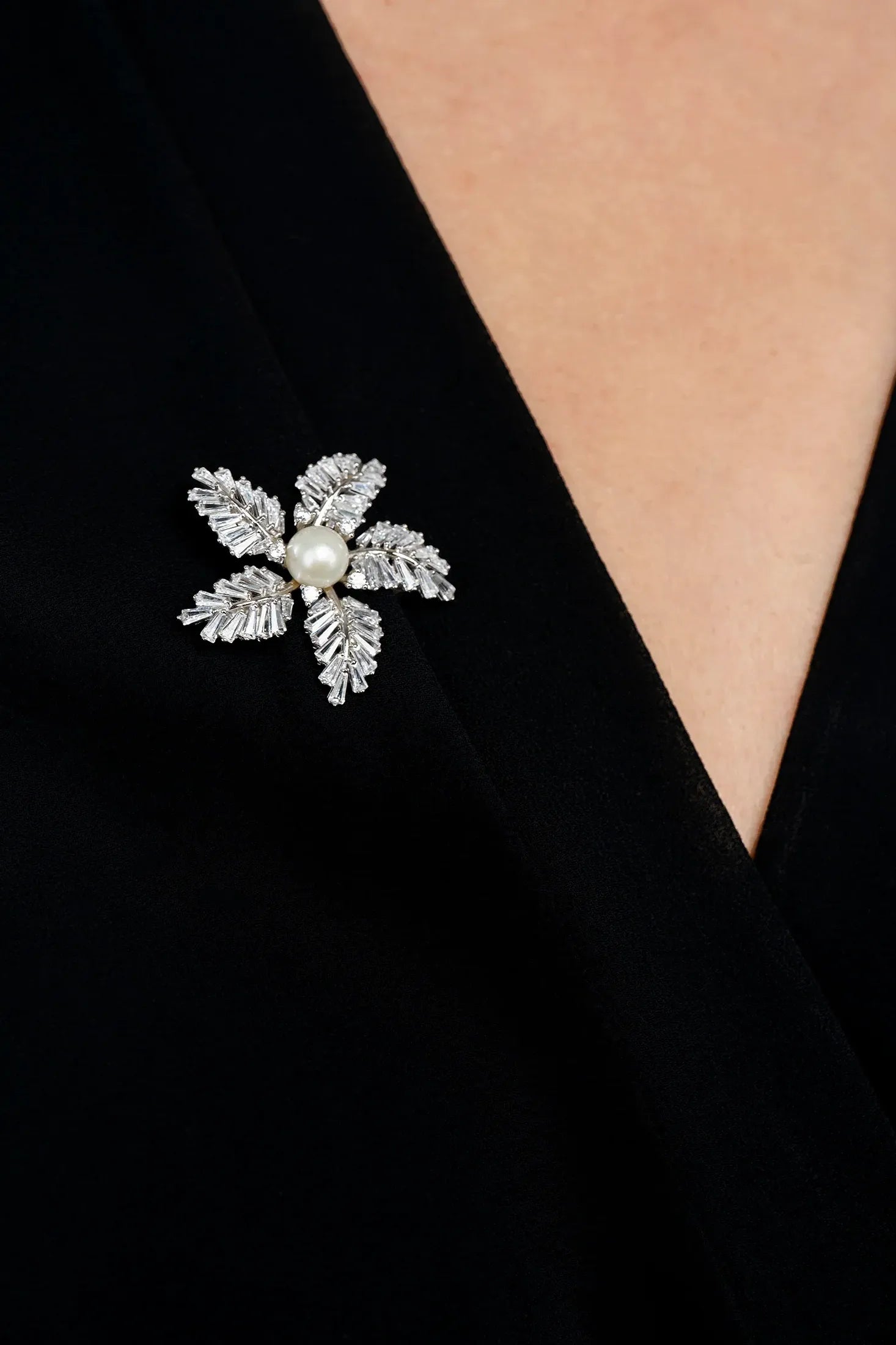 The brooch worn by a model.